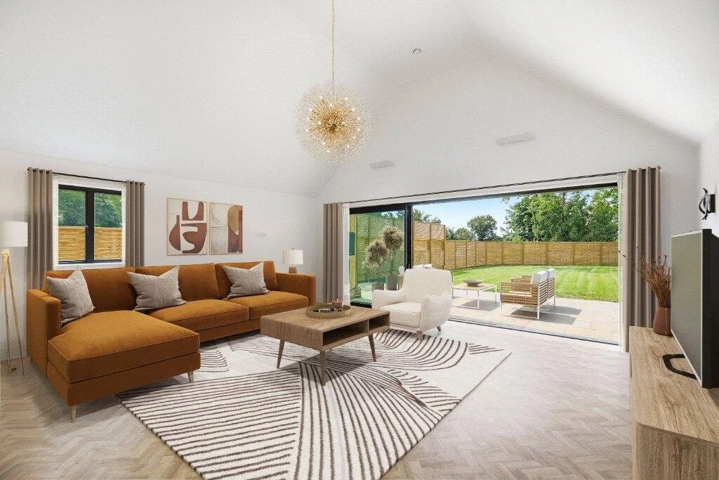 Bright modern living room with large sliding doors opening onto a landscaped garden and patio.