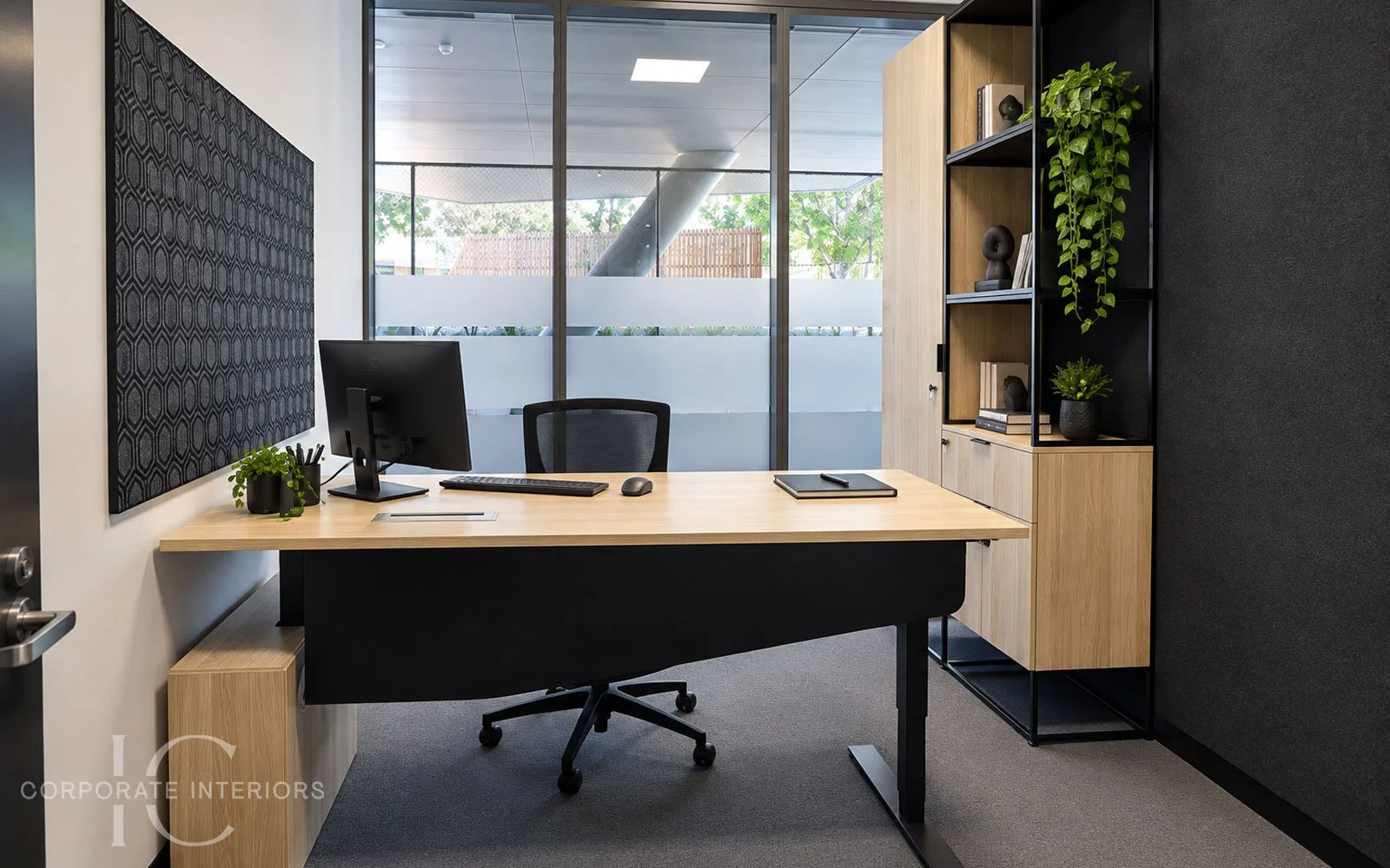Executive height adjustable office desk with custom timber and black metal storage, shelving and feature pinboard.
