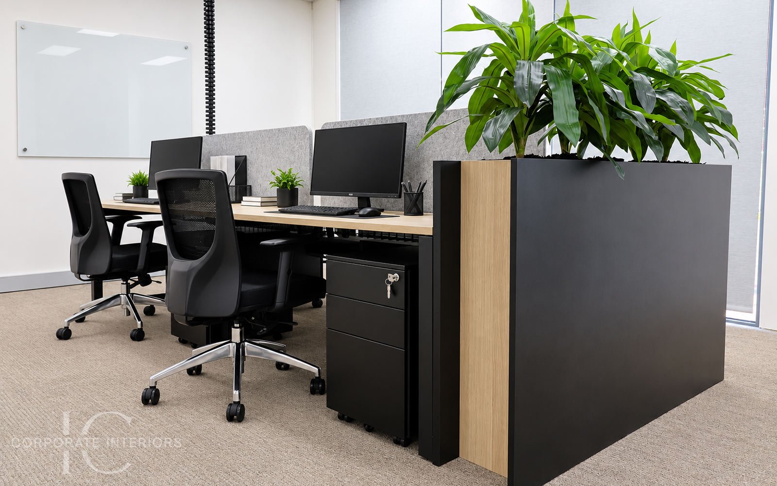Four-person office workstation pod with acoustic screens, ergonomic chairs and custom planter in Forest Hill, Melbourne.