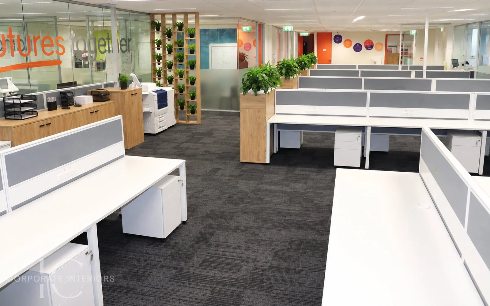 Open plan office fitout with workstations, storage planters and circulation areas
