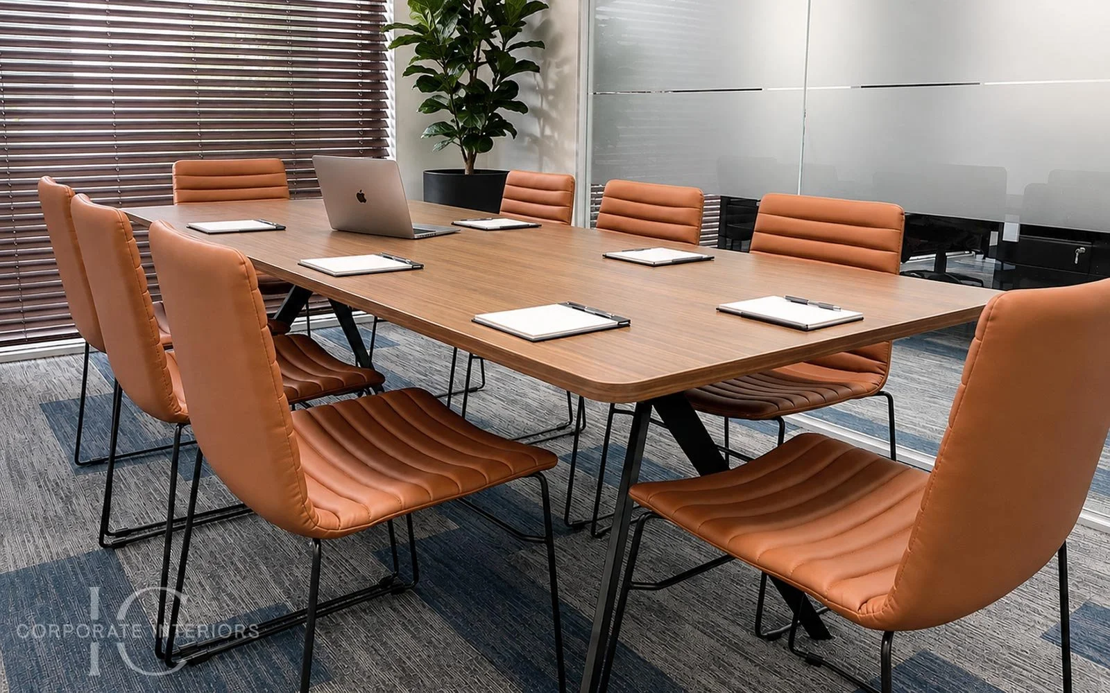 Contemporary Melbourne office boardroom with walnut timber boardroom table and tan upholstered meeting chairs.