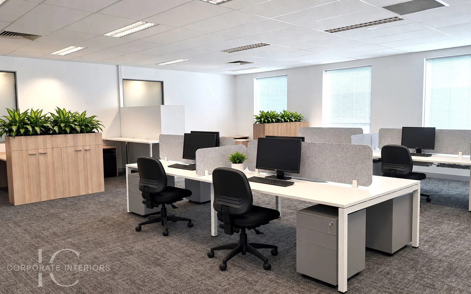 Commercial office workstations with task chairs, desk screens and storage
