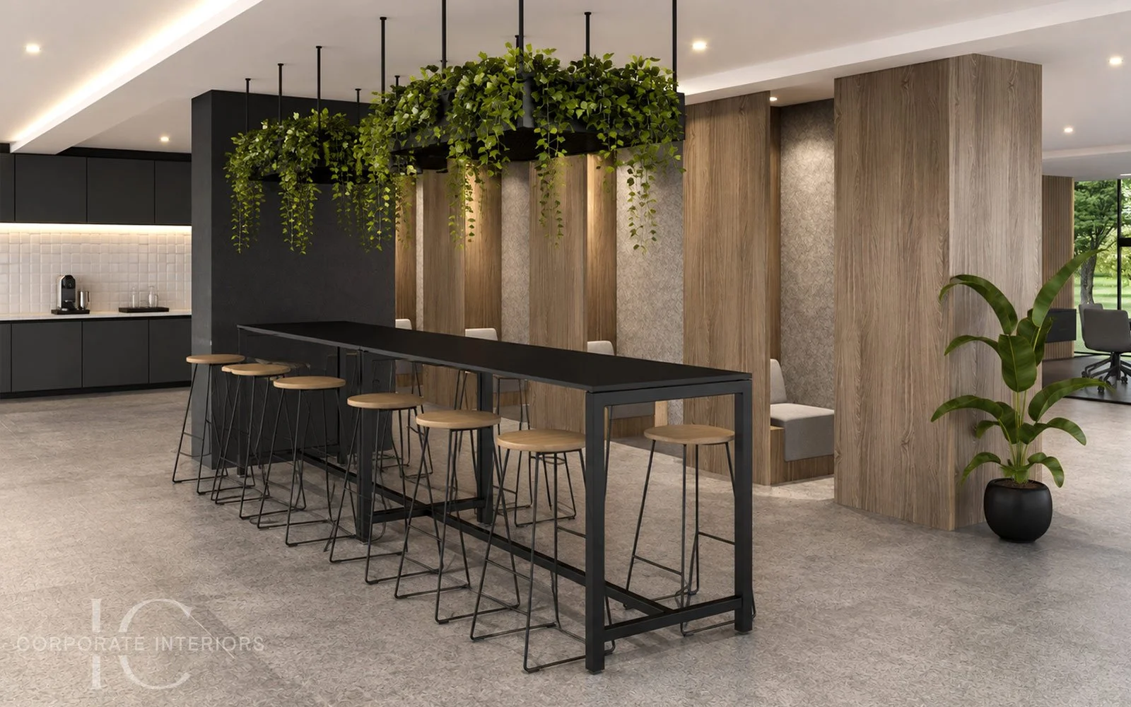 Modern office break room with a black high-top table surrounded by wooden stools, large hanging planters with green foliage, wooden wall panels, a small plant in a black pot, and a coffee station in the background.