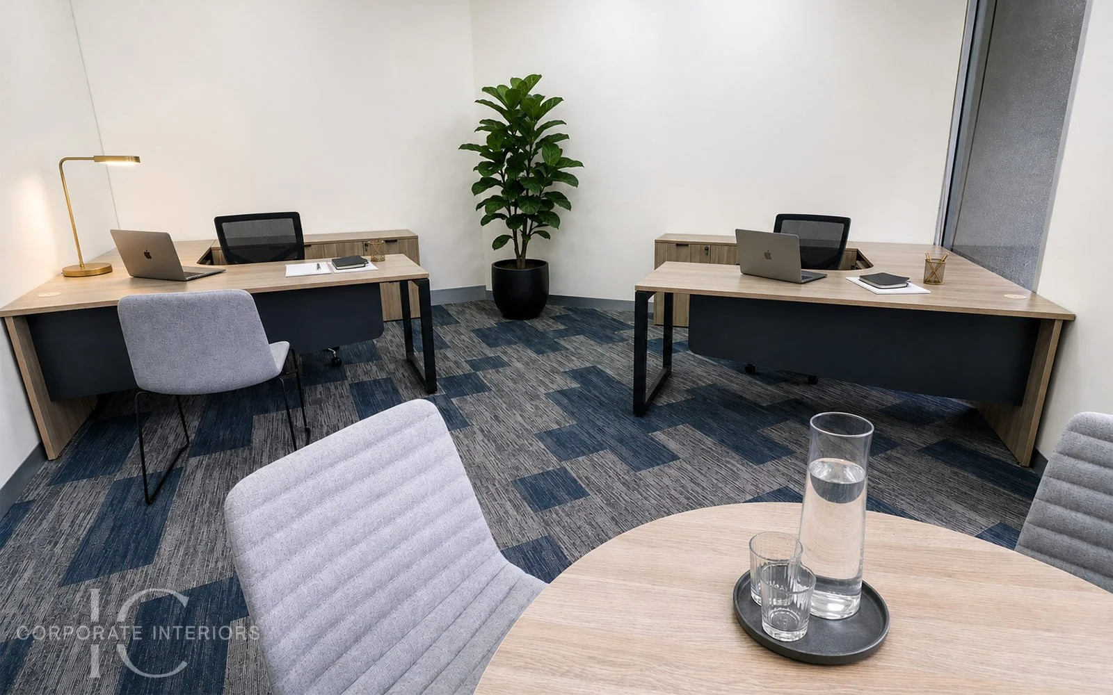 Executive office furniture featuring radial desks with returns, matching buffet storage, black mesh executive chairs and upholstered visitor seating for a Melbourne commercial office fitout.
