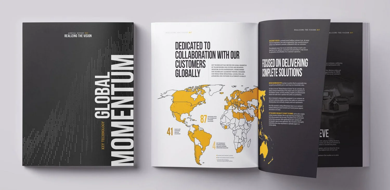 Open booklet with pages showing a world map in yellow and gray, with statistics about global locations and customer relationships, over a gray surface.
