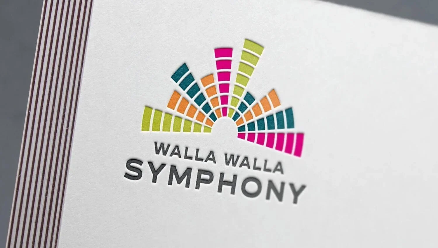 Logo of Walla Walla Symphony with colorful semi-circular design and text.