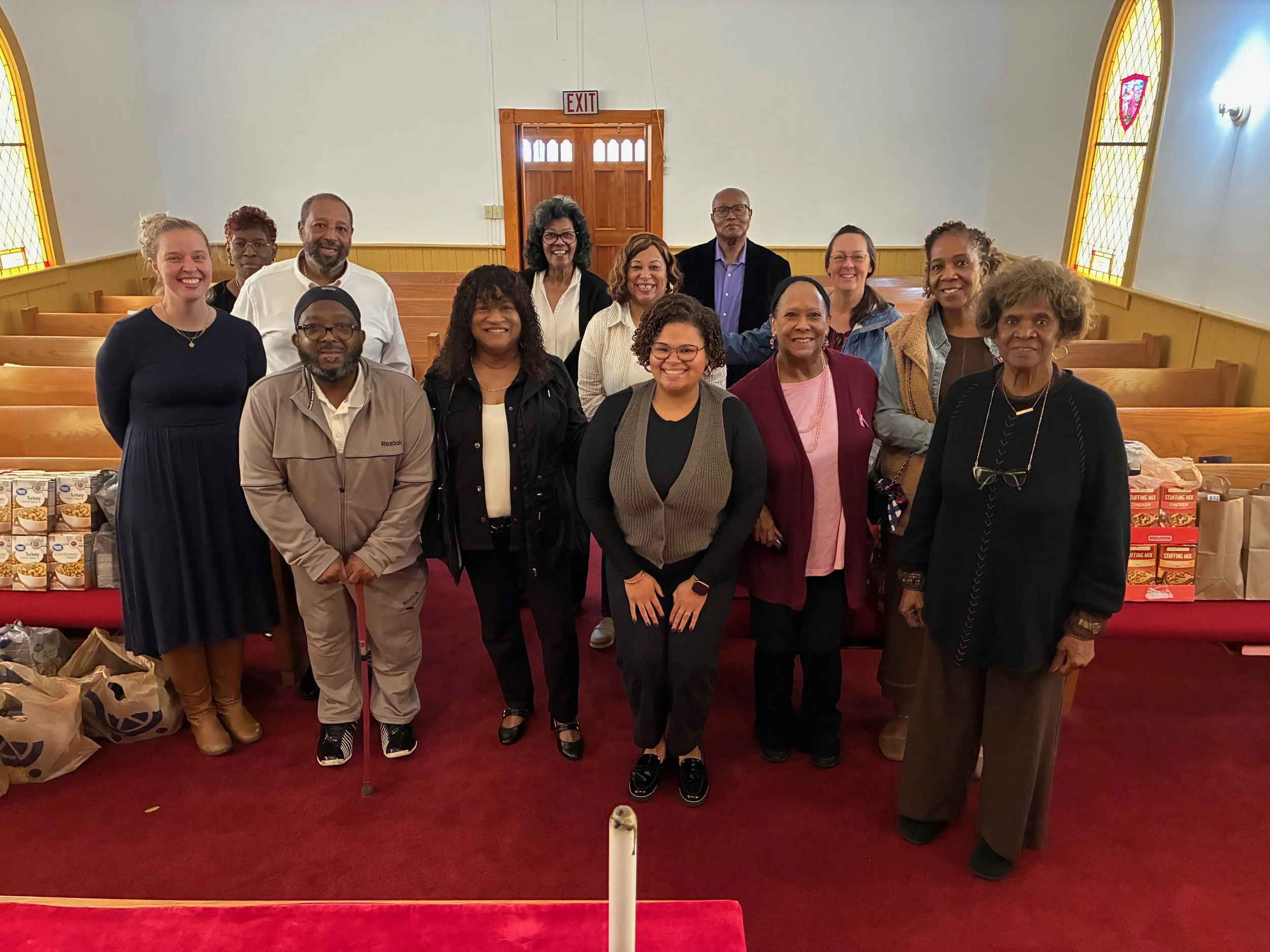 A group of people standing in a church sanctuary