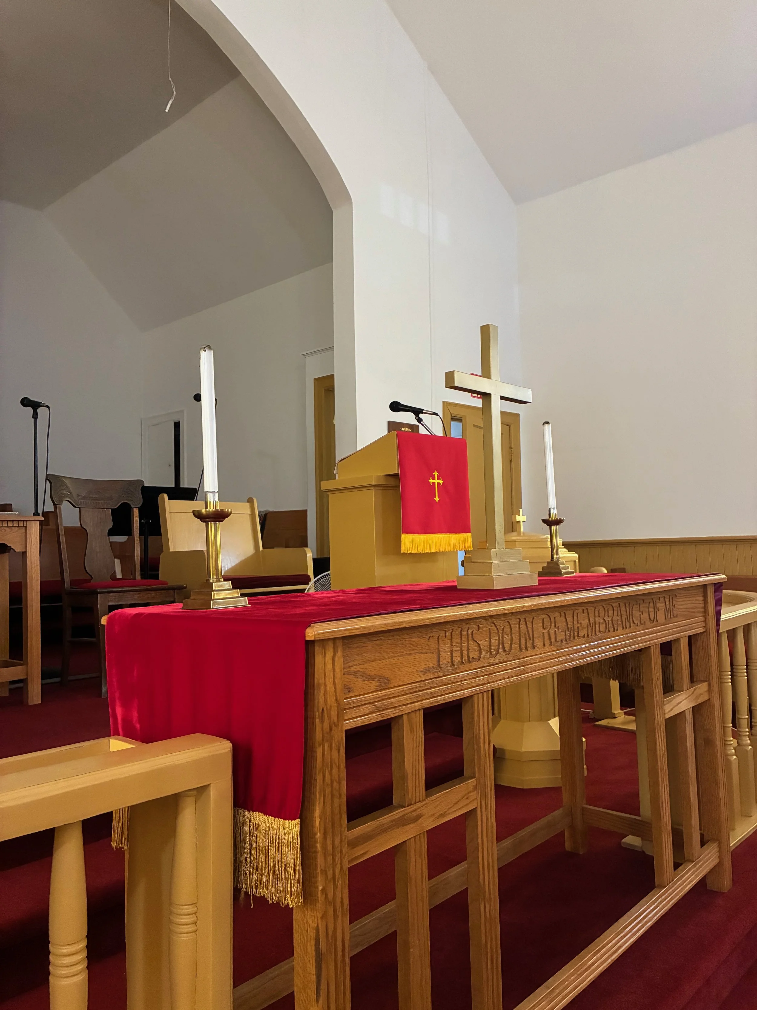 a photo of a cross and candles on a church alter table