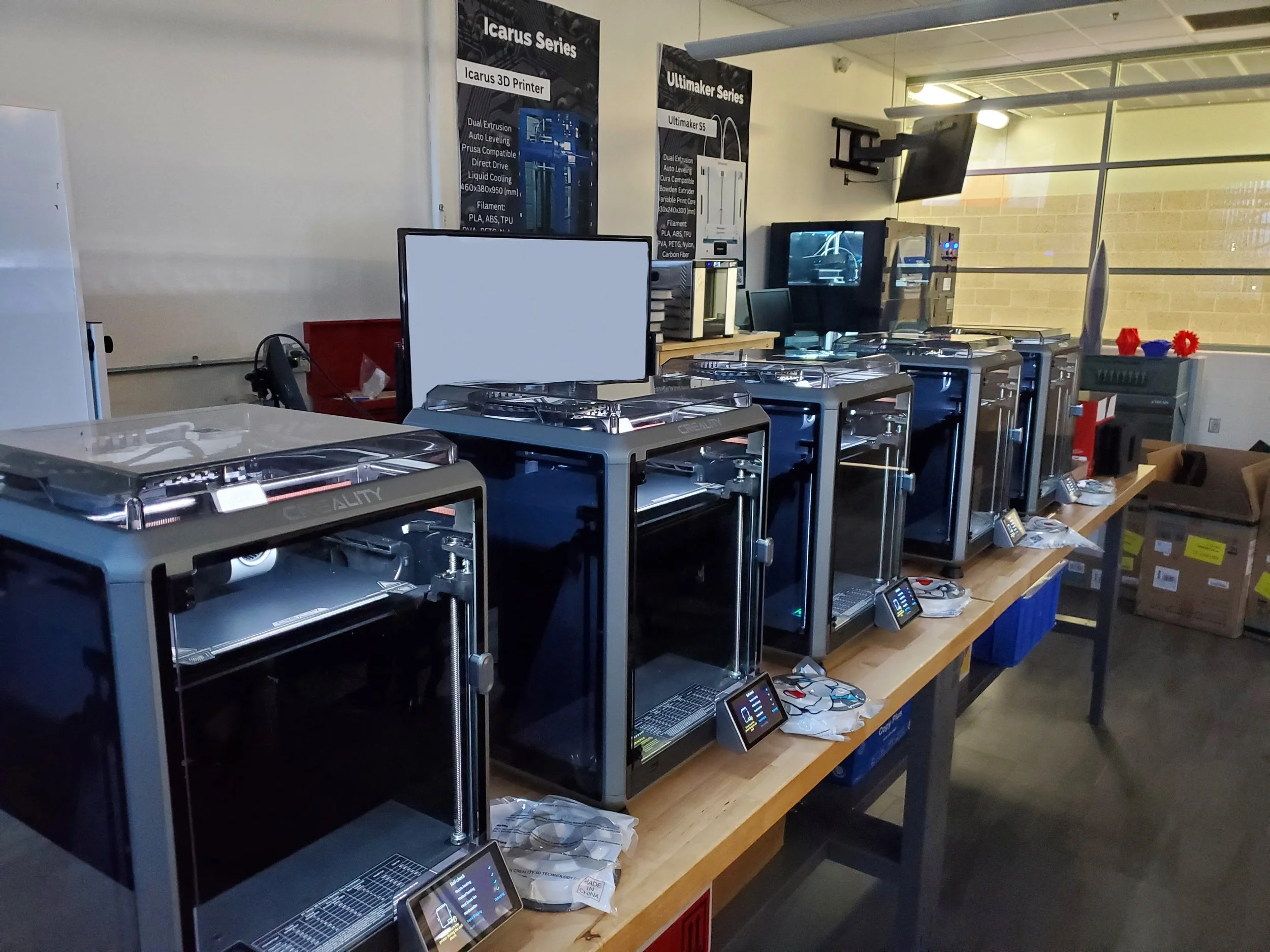 F-104 Lab at Western Michigan University showcasing 3D printers, active print jobs, and engineering prototypes