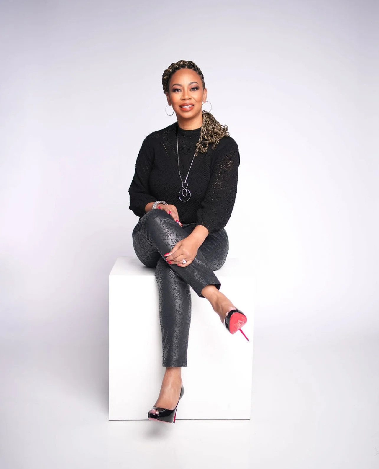 Dee Lockett seated in a studio portrait