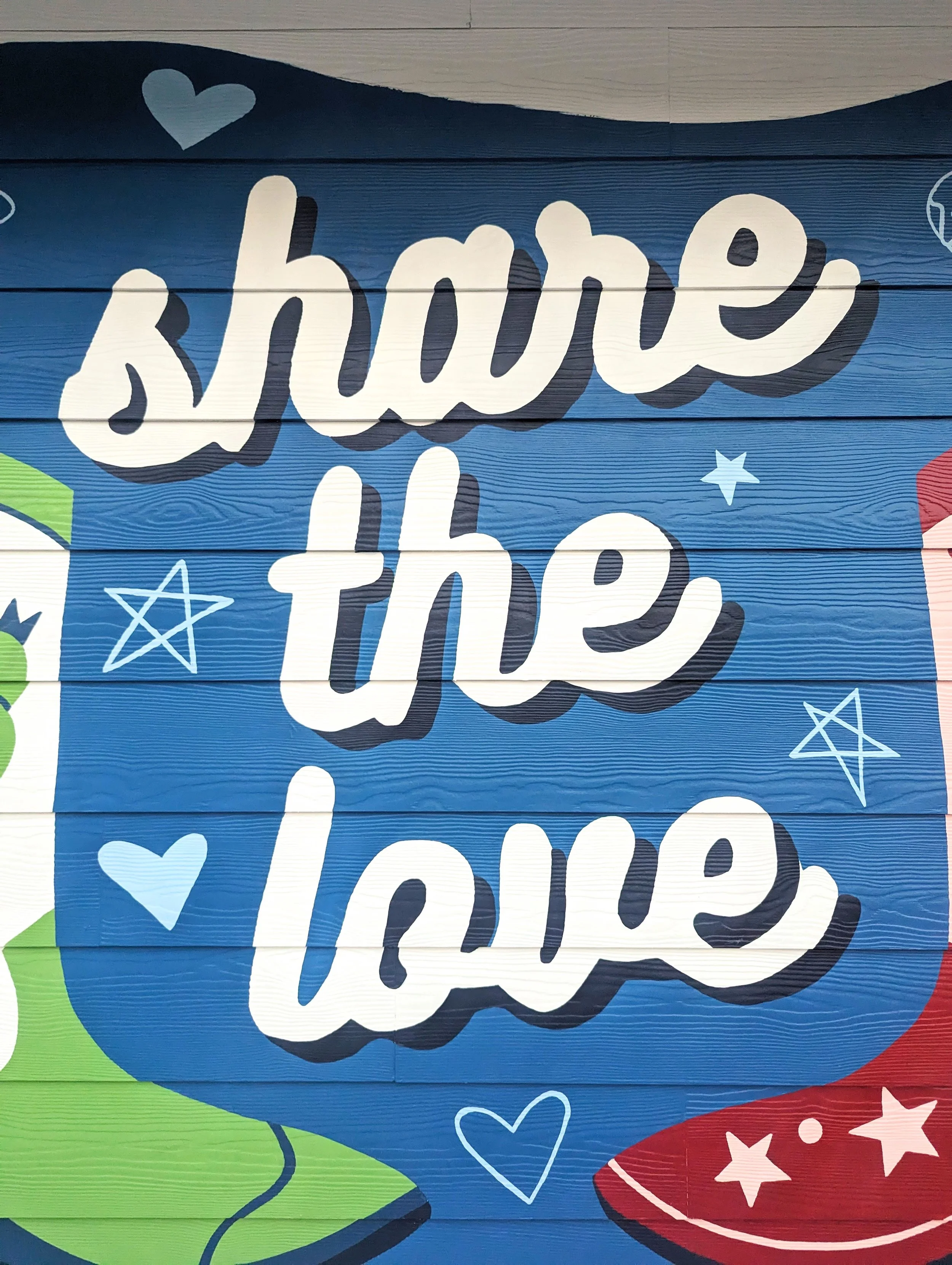 Round Rock, Texas short-term rental mural featuring the "Share the Love" message, cowboy boots, flowers, and Texas-inspired details.