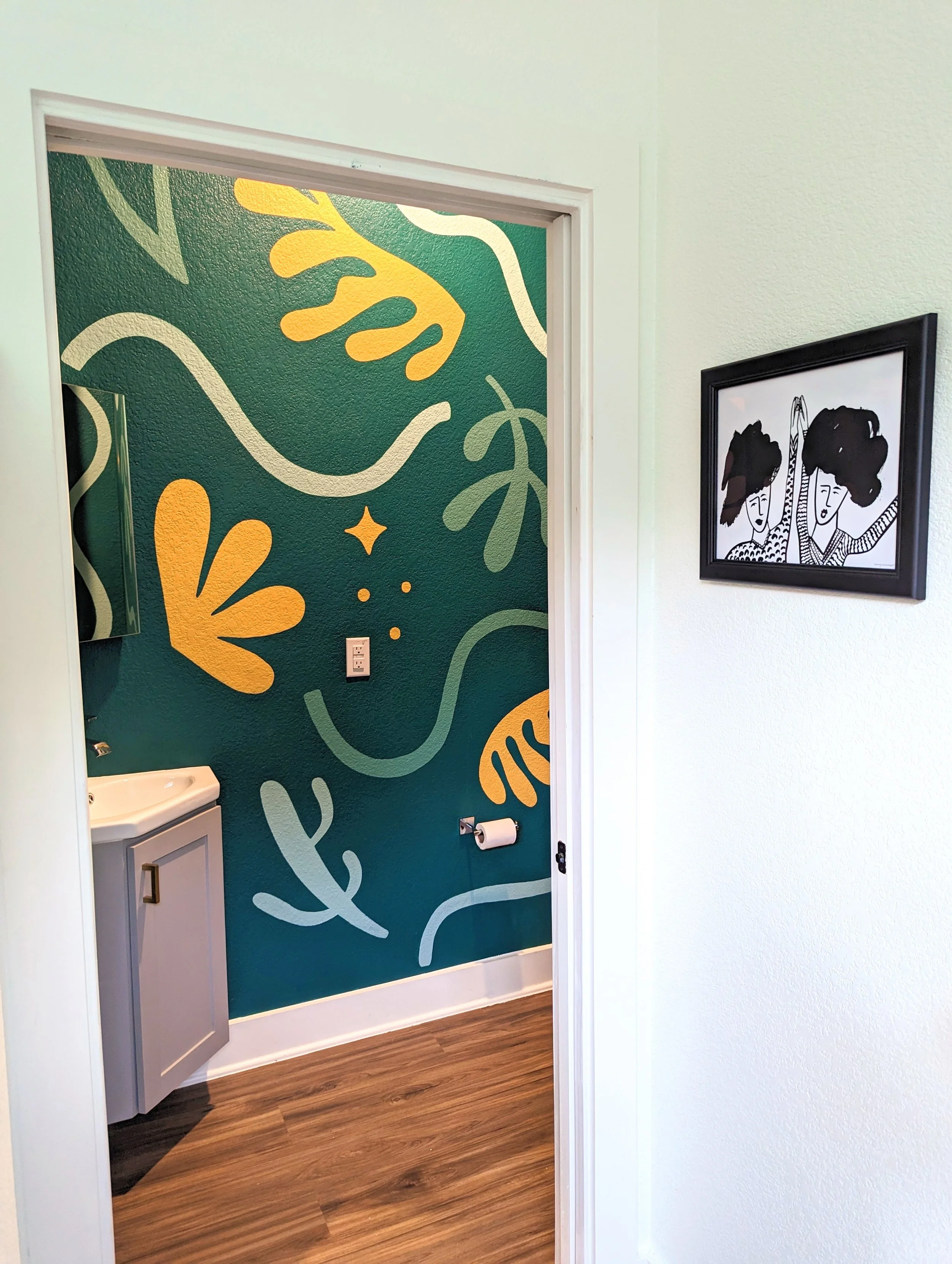 Emerald green color-drenched powder room bathroom mural in Austin featuring abstract organic shapes, flowers, and sparkles