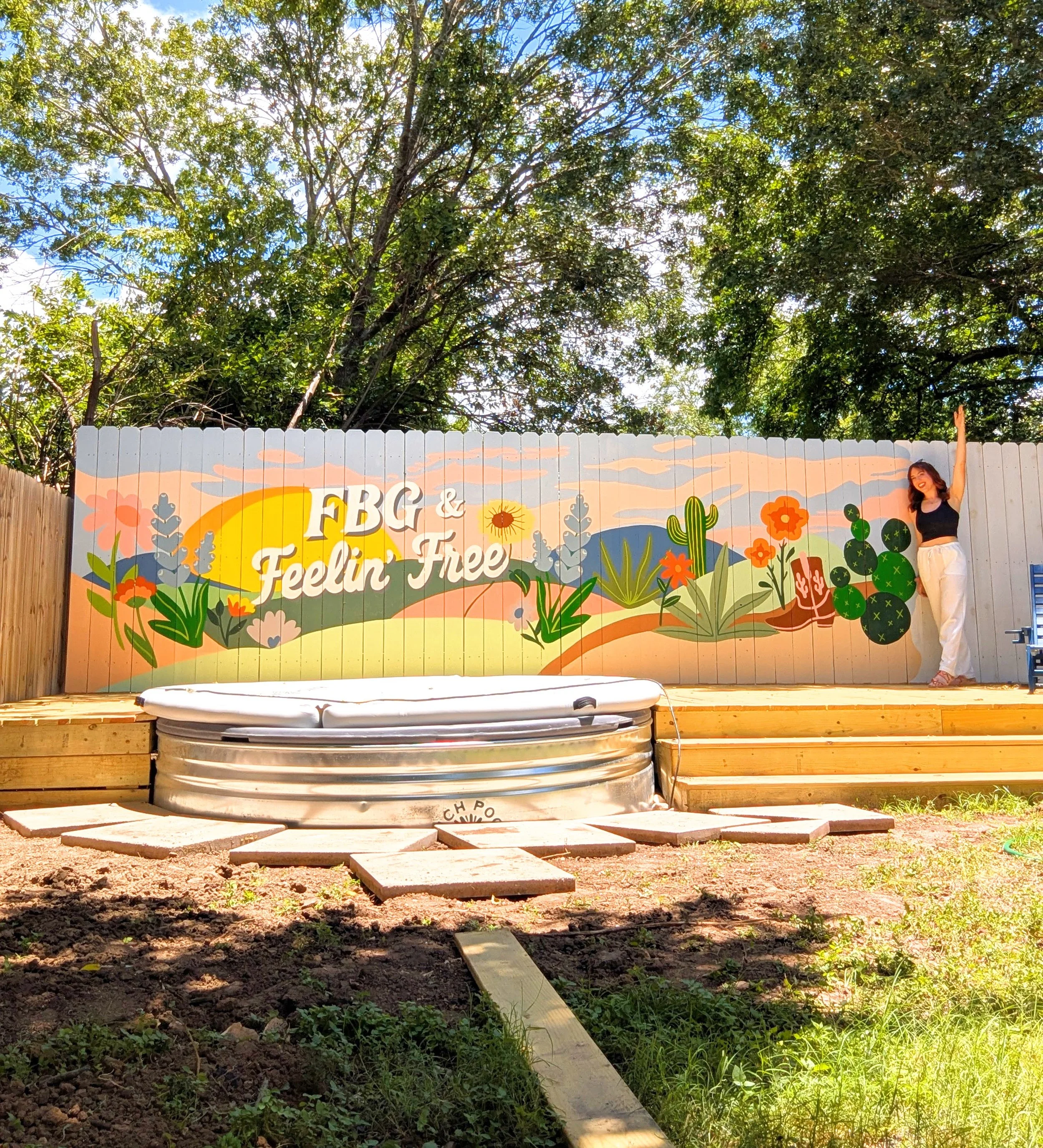 Fredericksburg, Texas short-term rental with a colorful Texas Hill Country-inspired fence mural and outdoor deck.