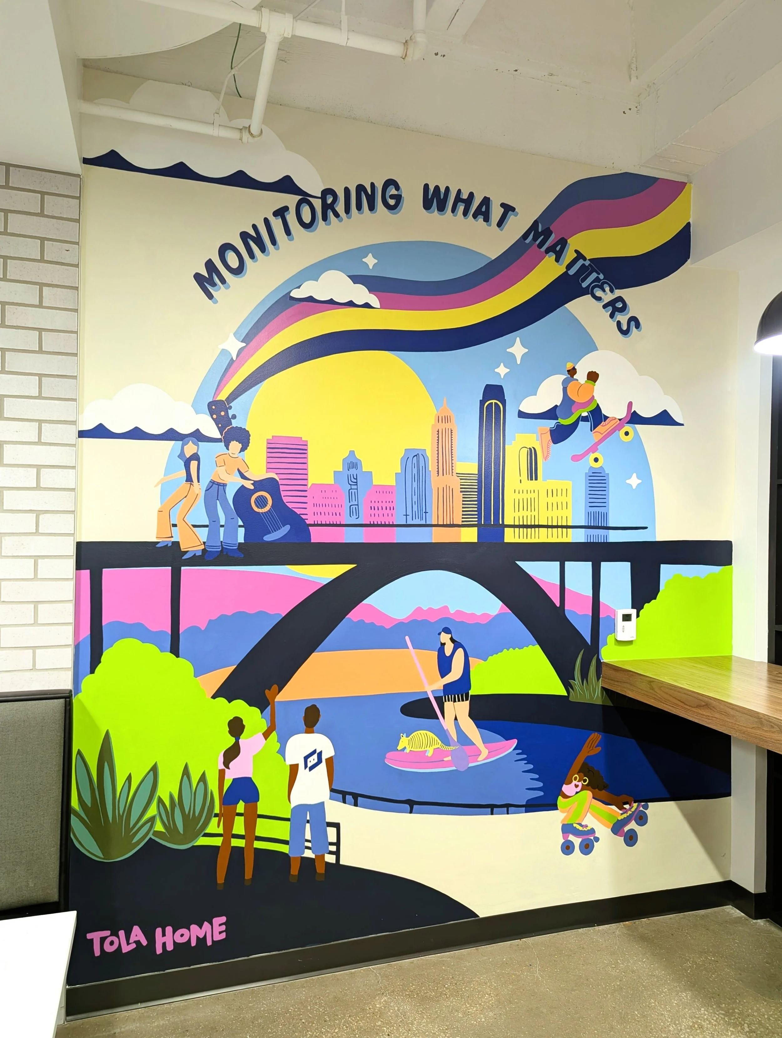 LogicMonitor office mural in Austin featuring colorful artwork, outdoor activities, Austin-inspired imagery, and the company's "Monitoring What Matters" message.