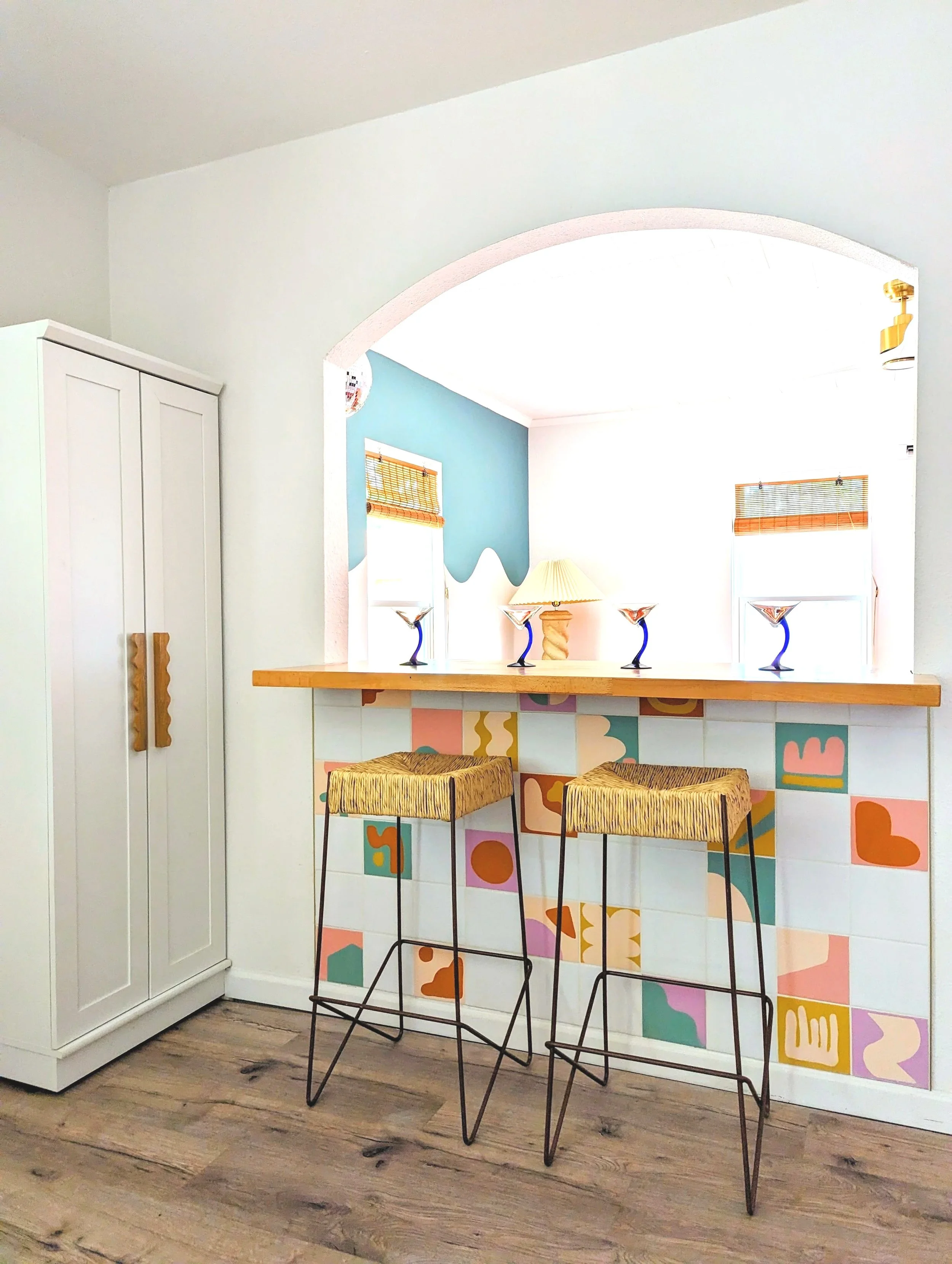 Hand-painted tiles on the pony bar at Howdy Hideaway, an eclectic Austin Airbnb interior designed by Tola Home.