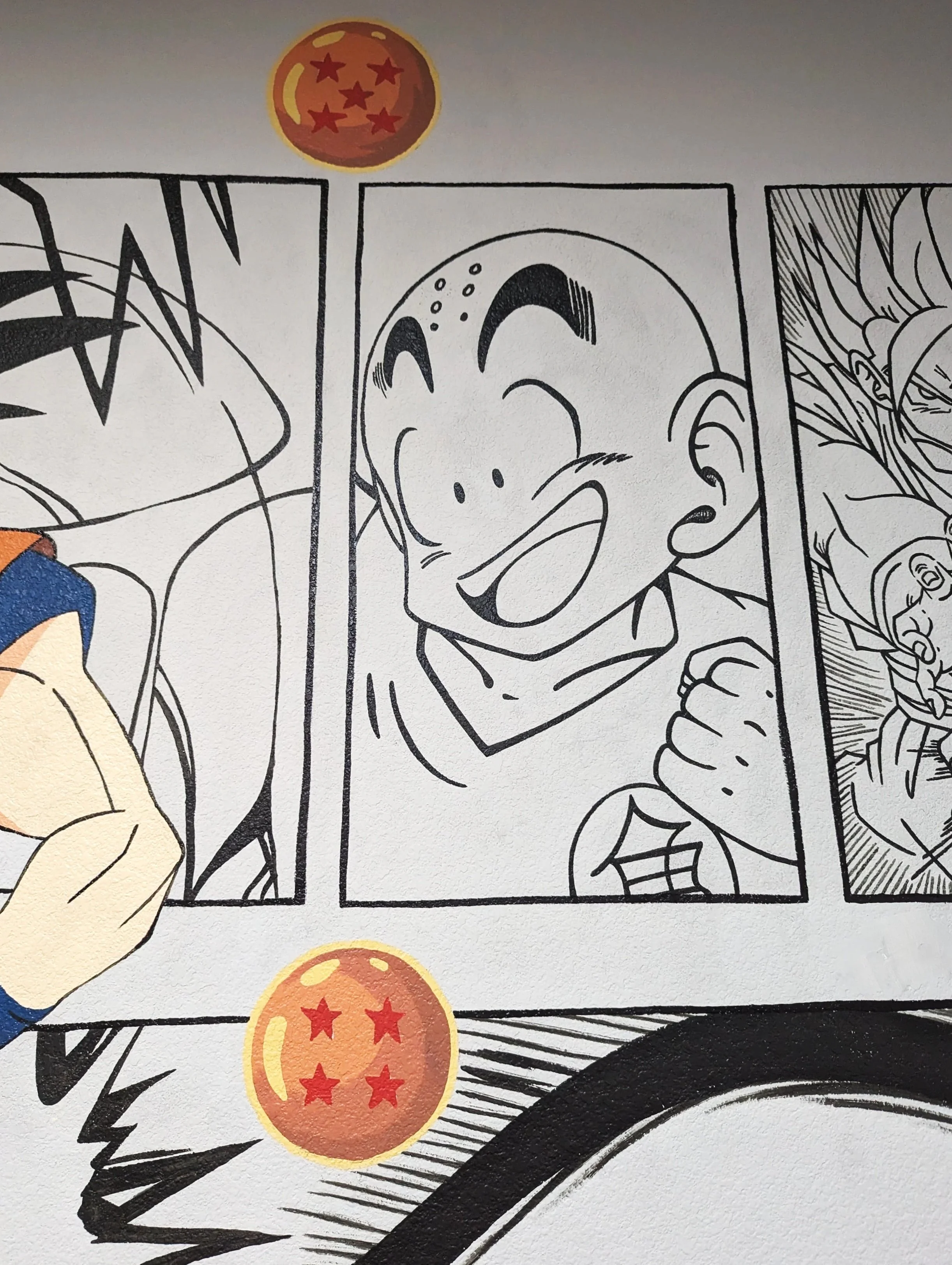 Austin, TX Dragon Ball Z mural featuring colorful Goku against a full wall of black-and-white manga panels.