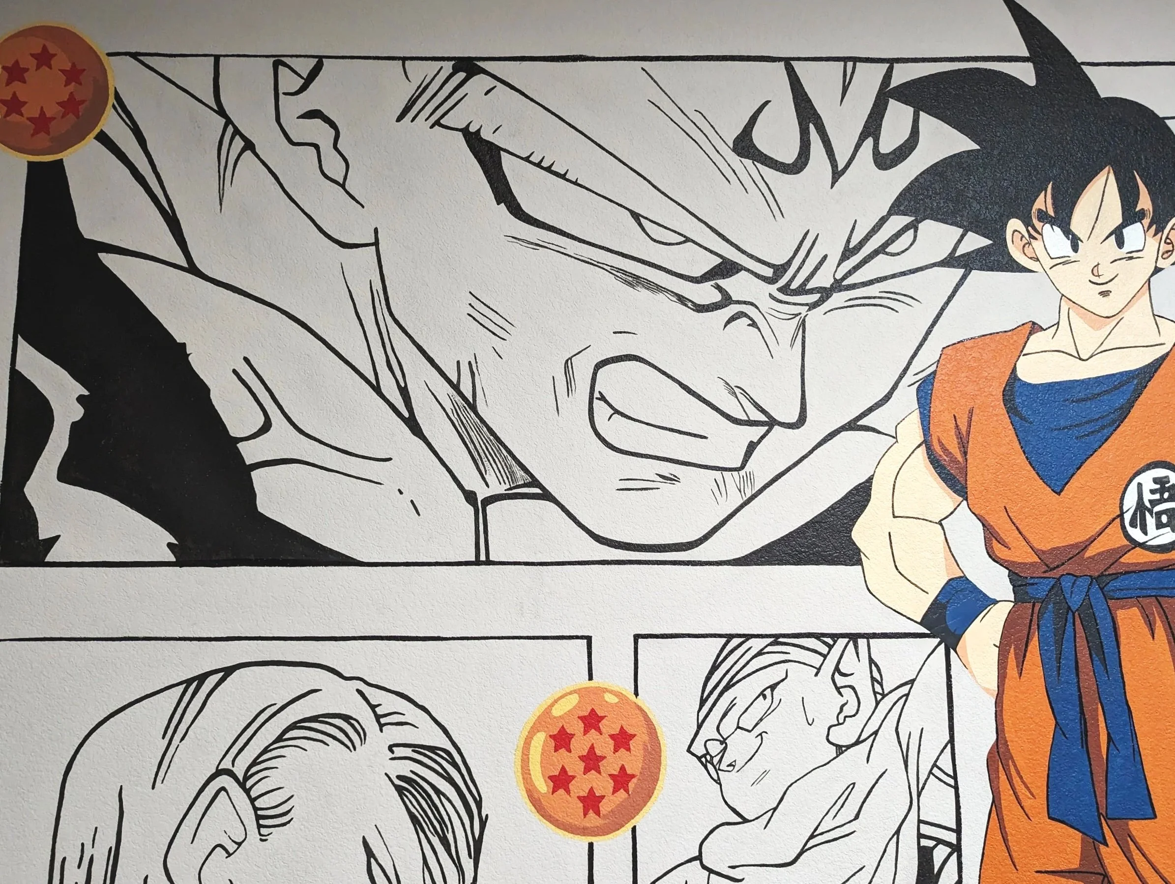 Anime Austin office mural featuring Goku from Dragon Ball Z with black-and-white manga panels covering the wall behind him.