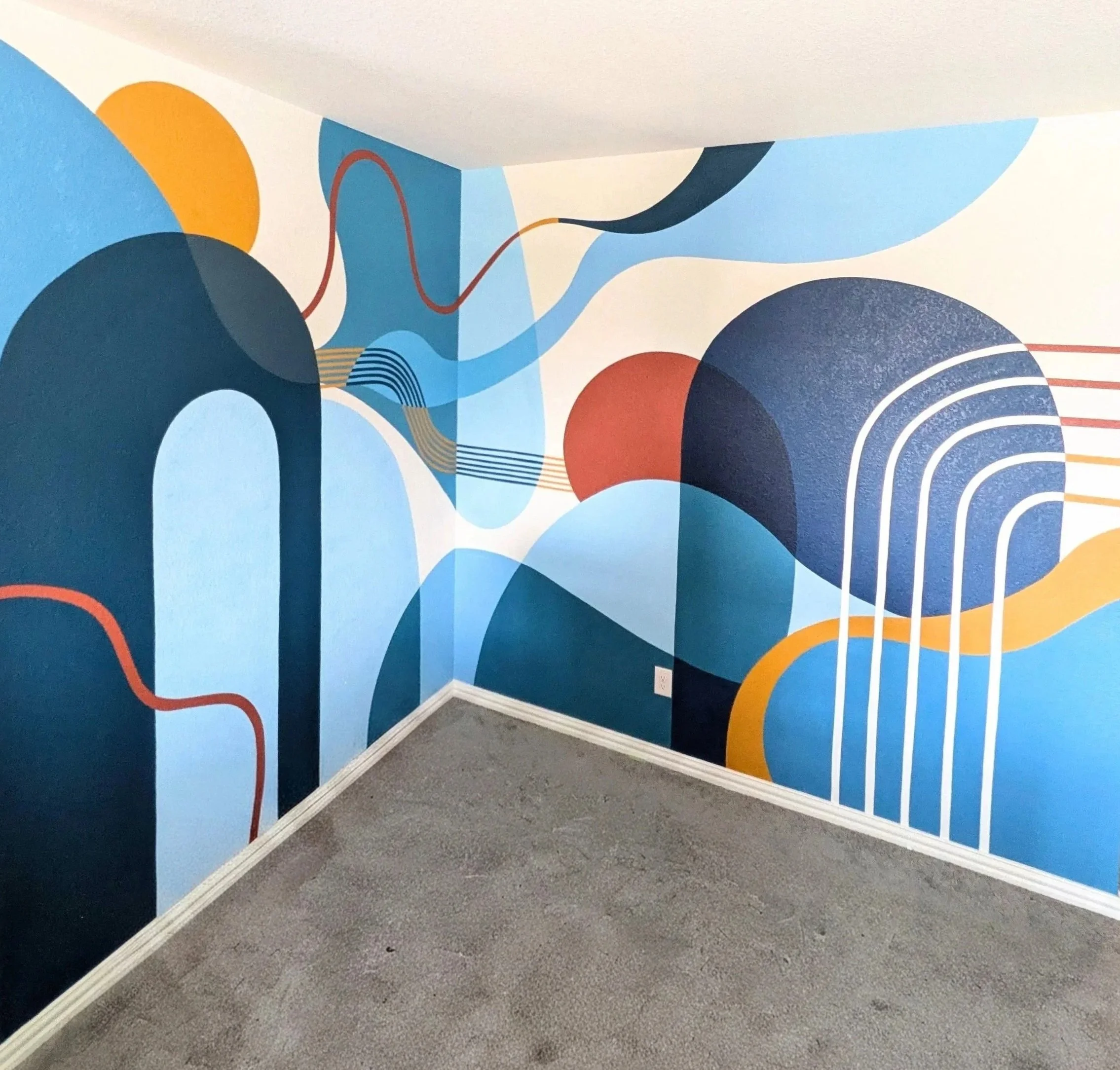 Blue abstract nursery mural in Buda, Texas featuring organic shapes, sweeping curves, and layered blue tones.