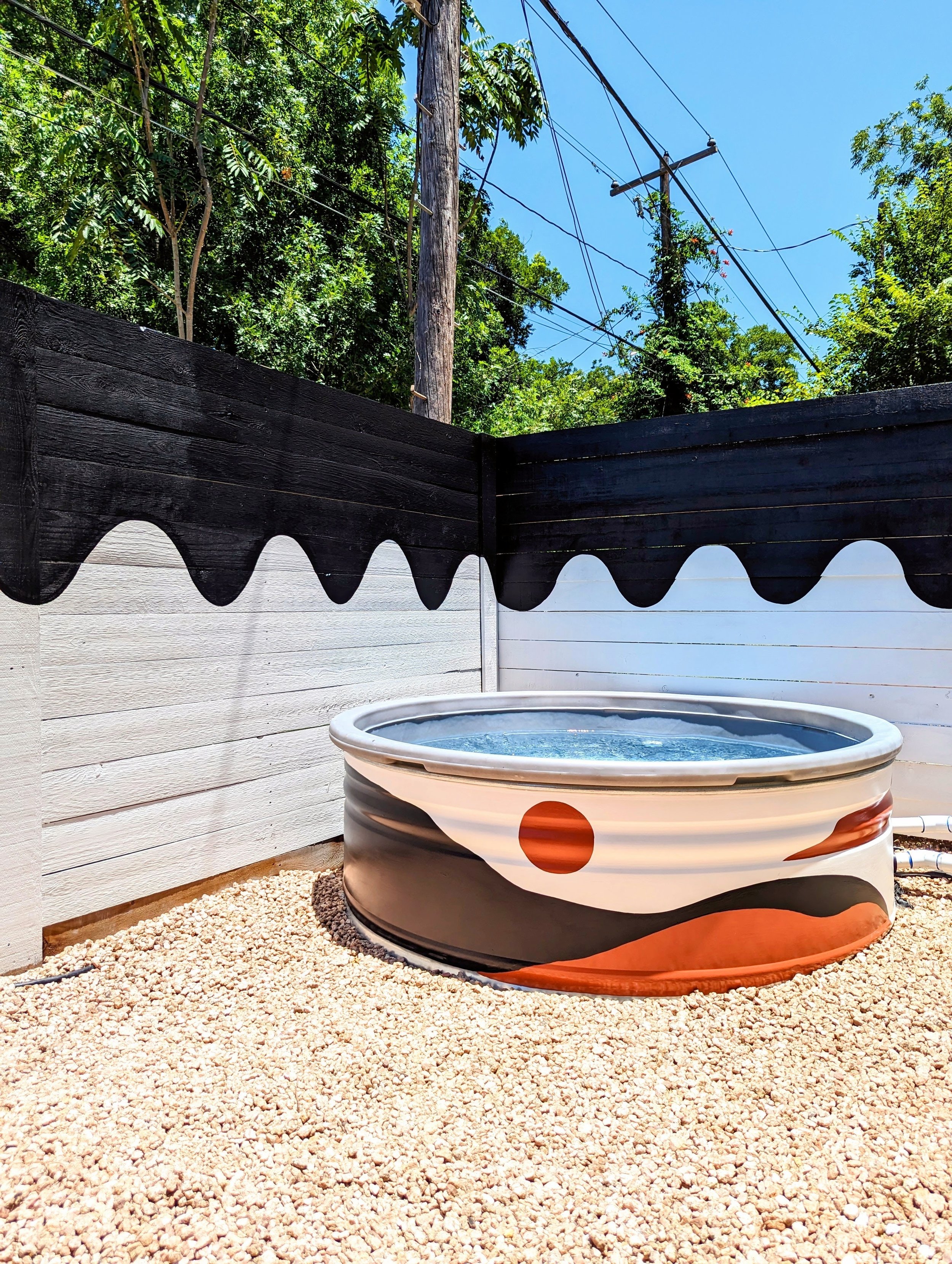 East Austin backyard mural featuring a painted cowboy pool, colorful fence, and desert-inspired artwork.