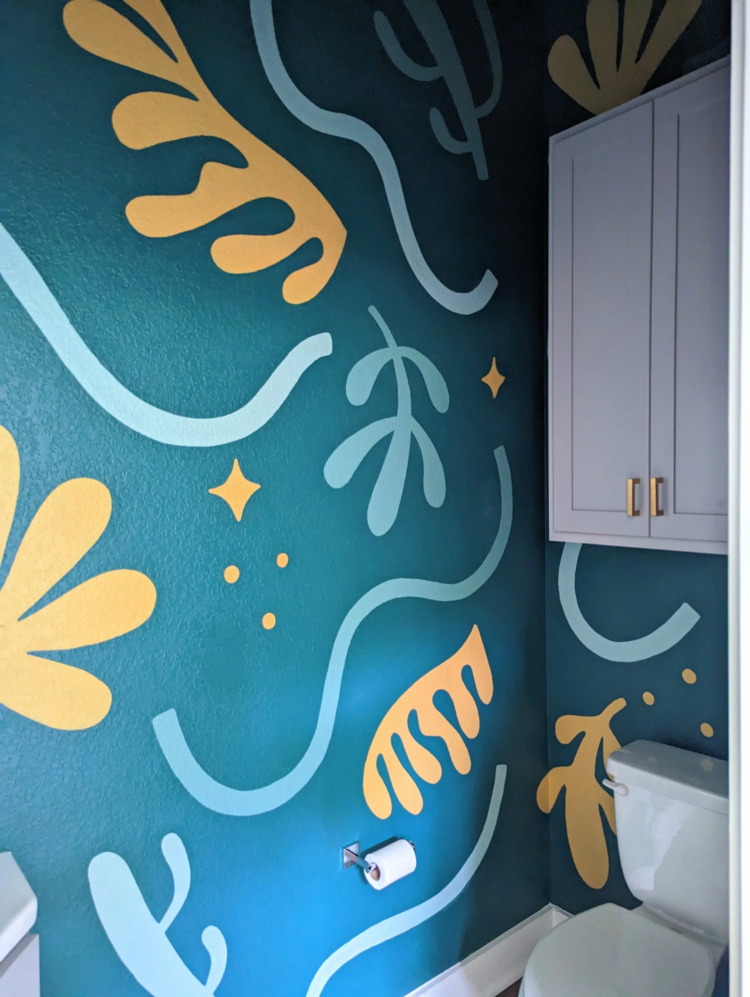 Colorful powder room mural in Austin with hand-painted flowers, abstract organic shapes, and a deep emerald green palette.