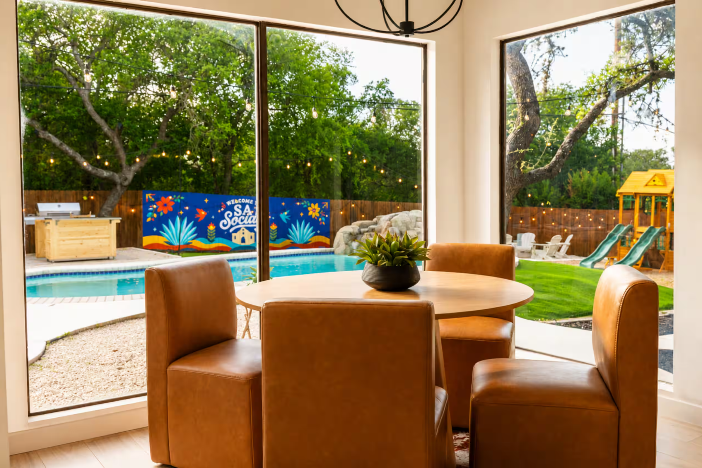 San Antonio short-term rental with a colorful exterior fence mural overlooking the pool and backyard.