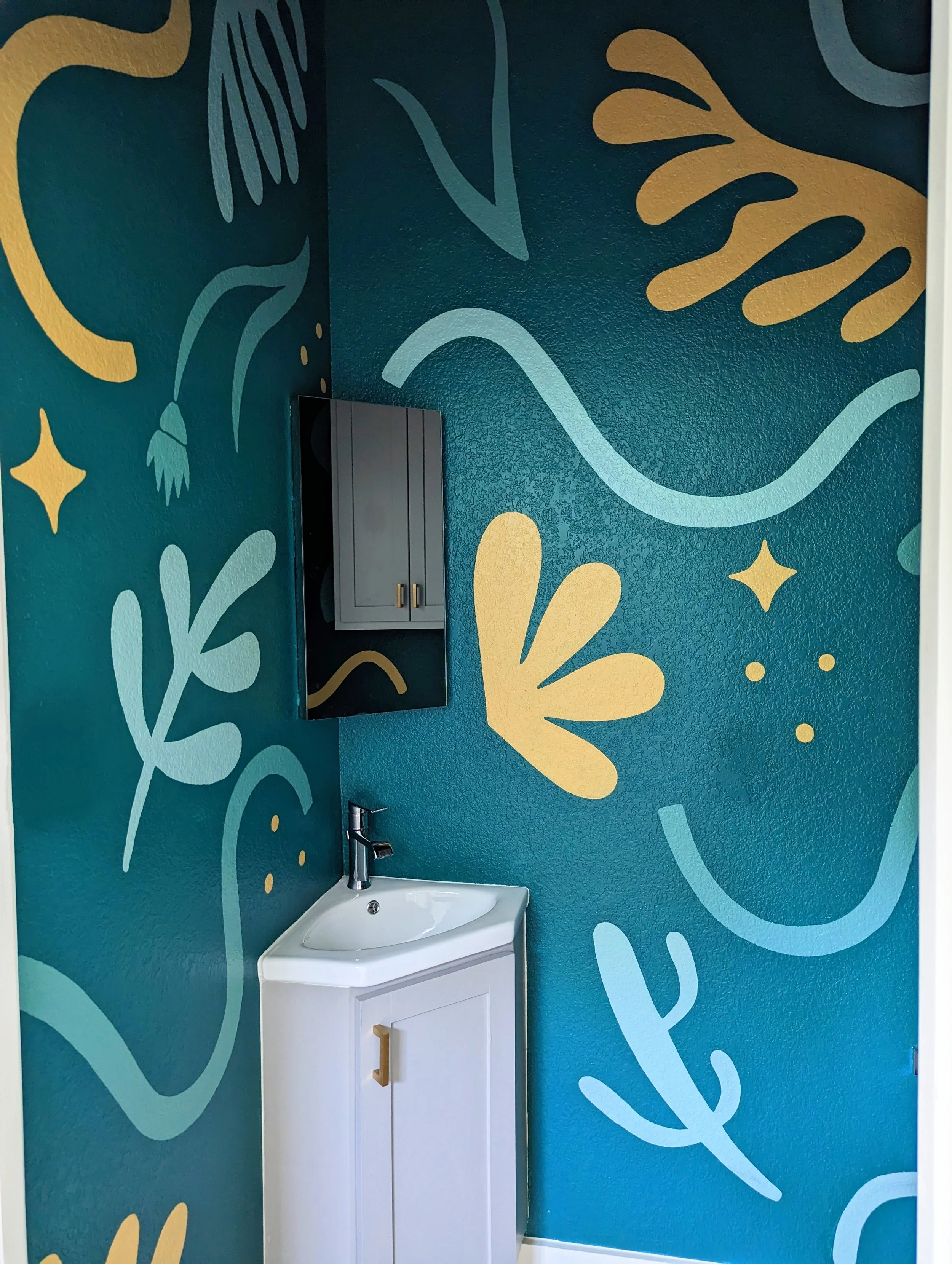 Austin bathroom mural featuring jewel-toned green walls, colorful flowers, organic shapes, and painted sparkles.