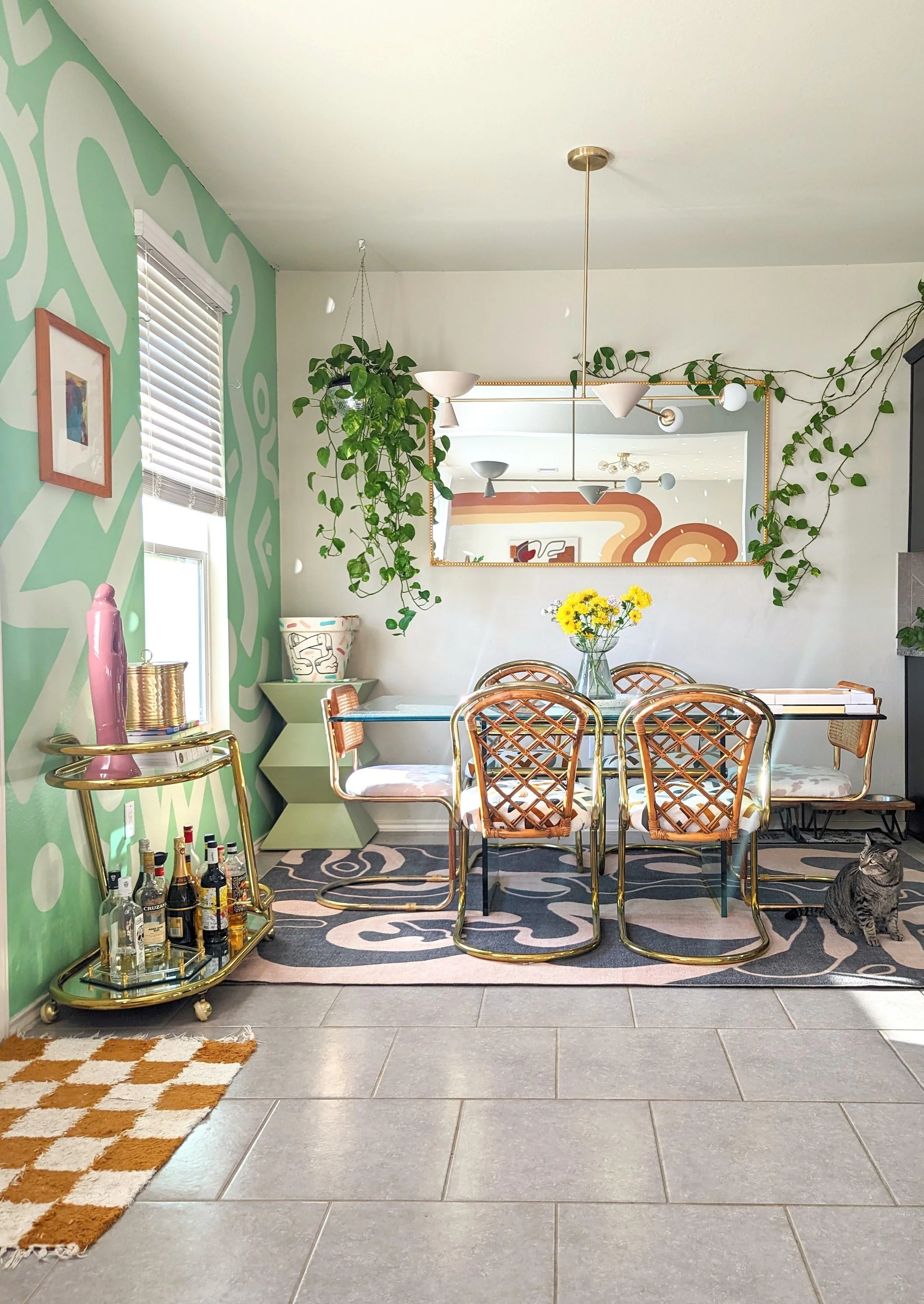 Colorful dining room in an Austin-area home featuring original artwork, DIY projects, vintage finds, and eclectic decor, featured in Apartment Therapy.
