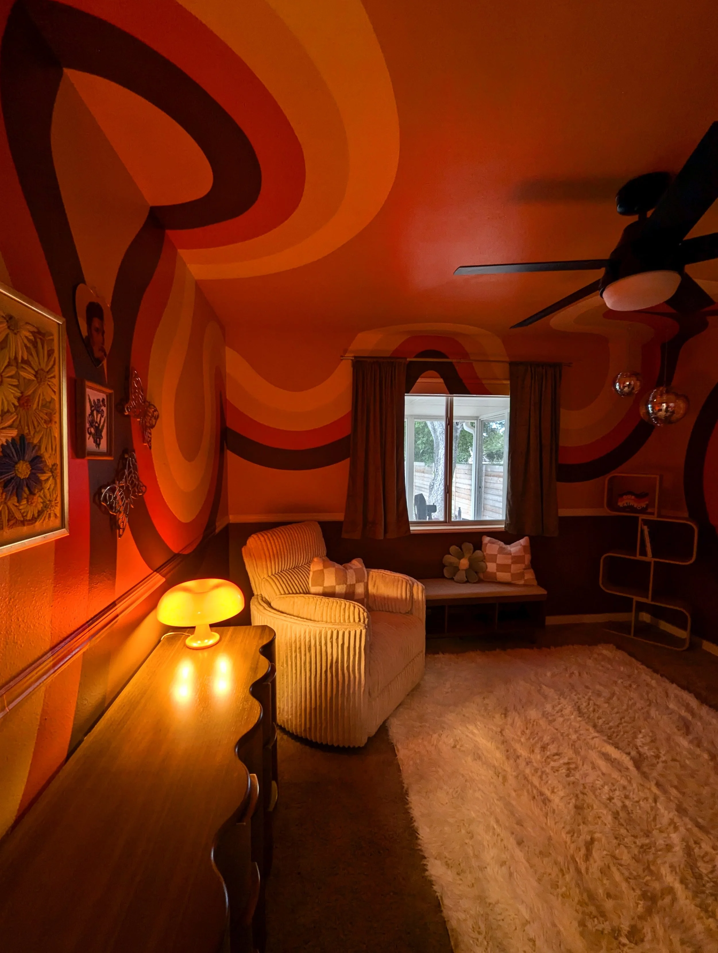 Austin nursery interior featuring a full-room retro mural, hanging disco balls, vintage finds, and playful decor.