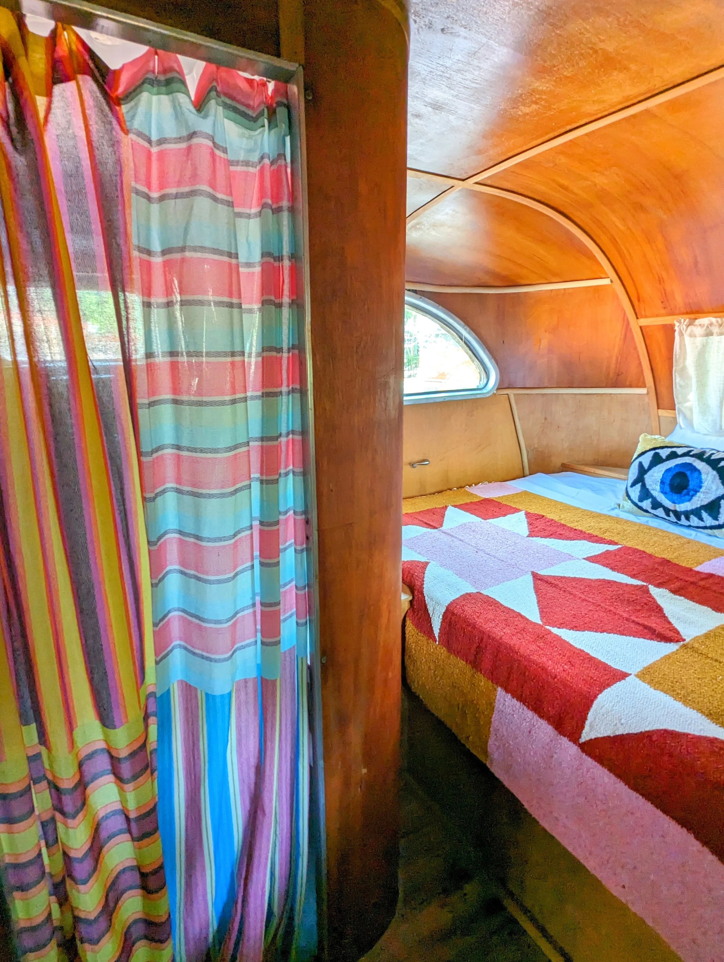 Vintage Spartan trailer interior at an Austin Airbnb inspired by El Cosmico in Marfa, featuring eclectic vintage furnishings and collected decor.