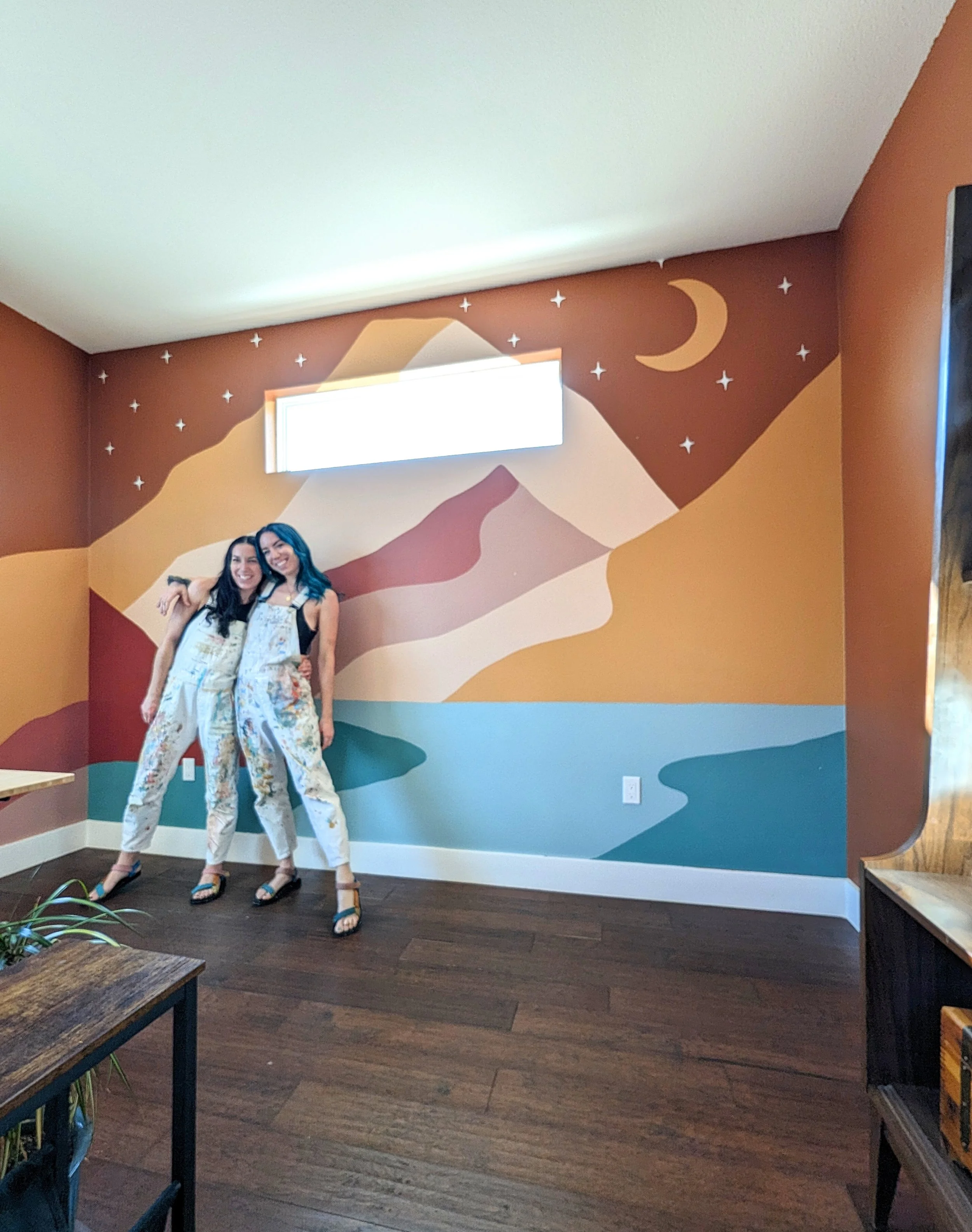 Austin, Texas nursery mural featuring a painted mountain landscape and colorful abstract shapes.