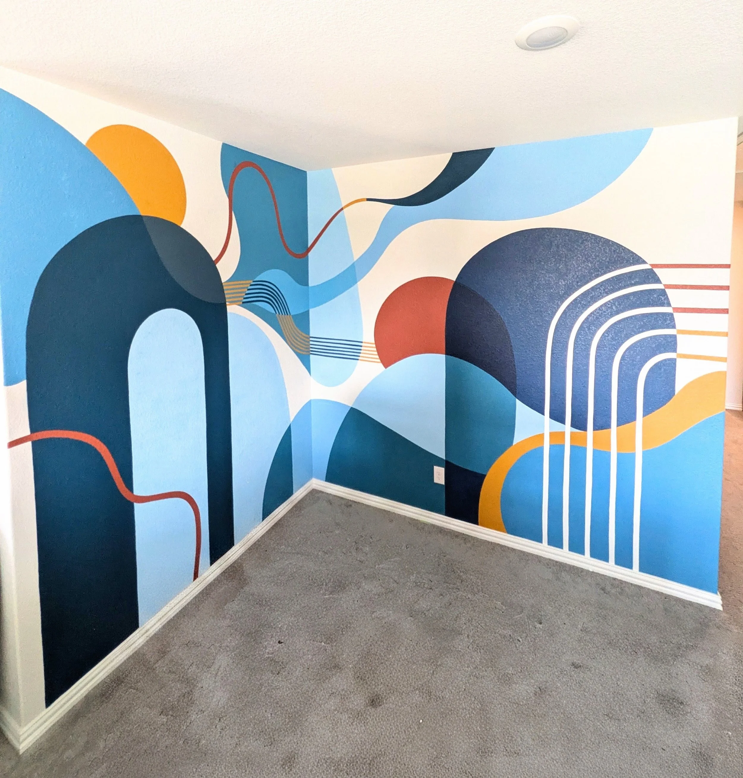 Buda, Texas playroom mural featuring bold abstract shapes and colorful geometric artwork designed around the room's architecture.