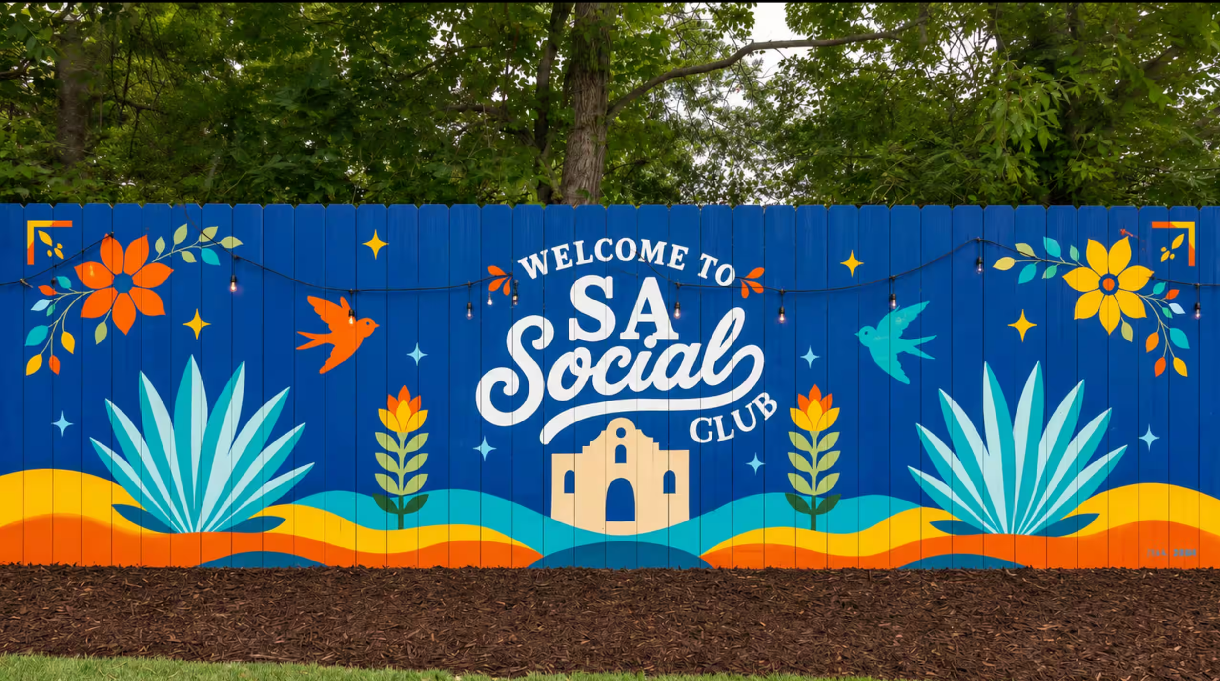 SA Social Club exterior fence mural for a San Antonio short-term rental featuring colorful flowers, birds, native plants, and Texas-inspired artwork.