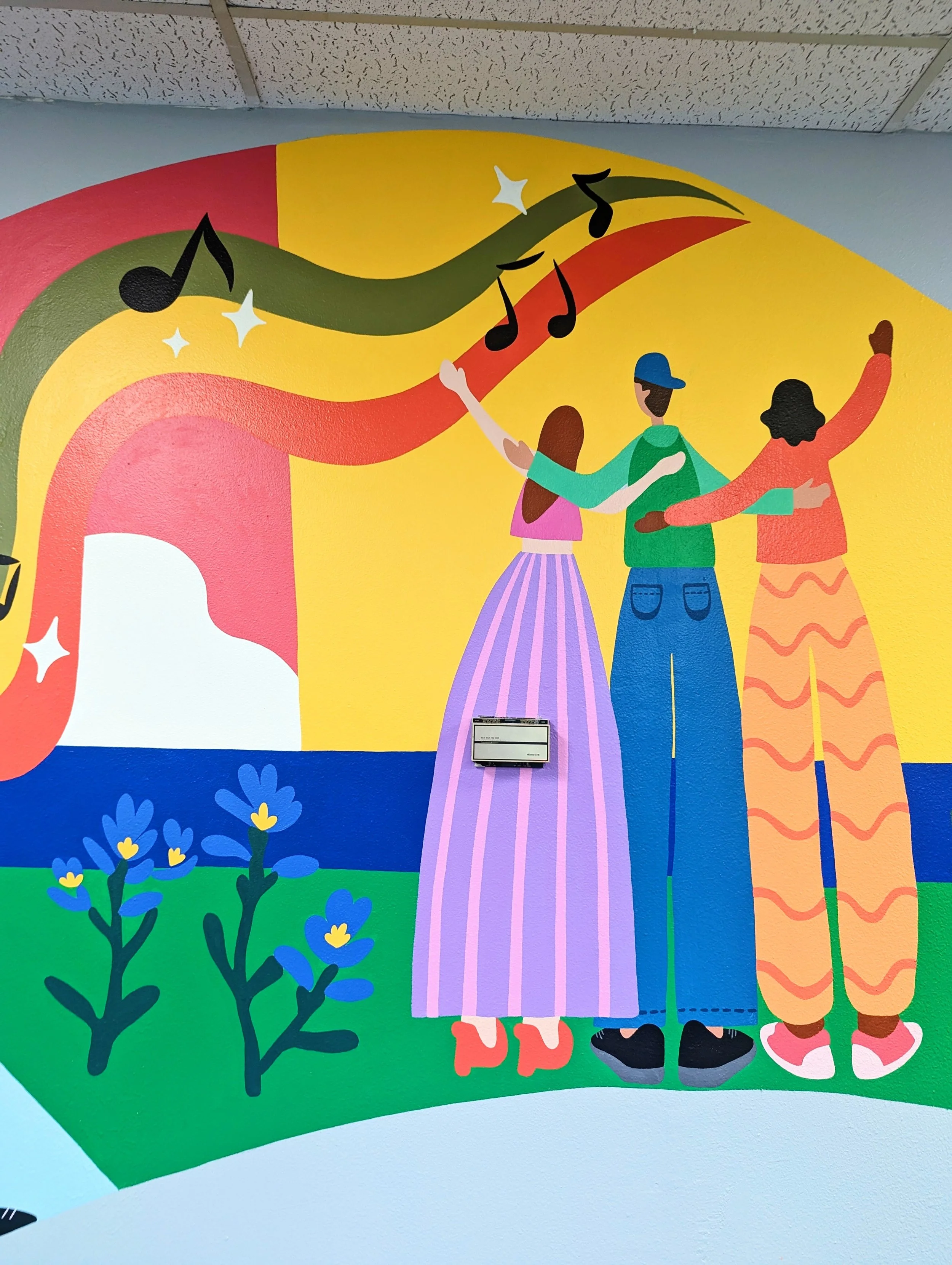 Colorful mural for Centex Auto Title, depicting an Austin city skyline with tall buildings, a person playing a guitar with musical notes, a rainbow stretching across the sky, a mountain, clouds, and trees.