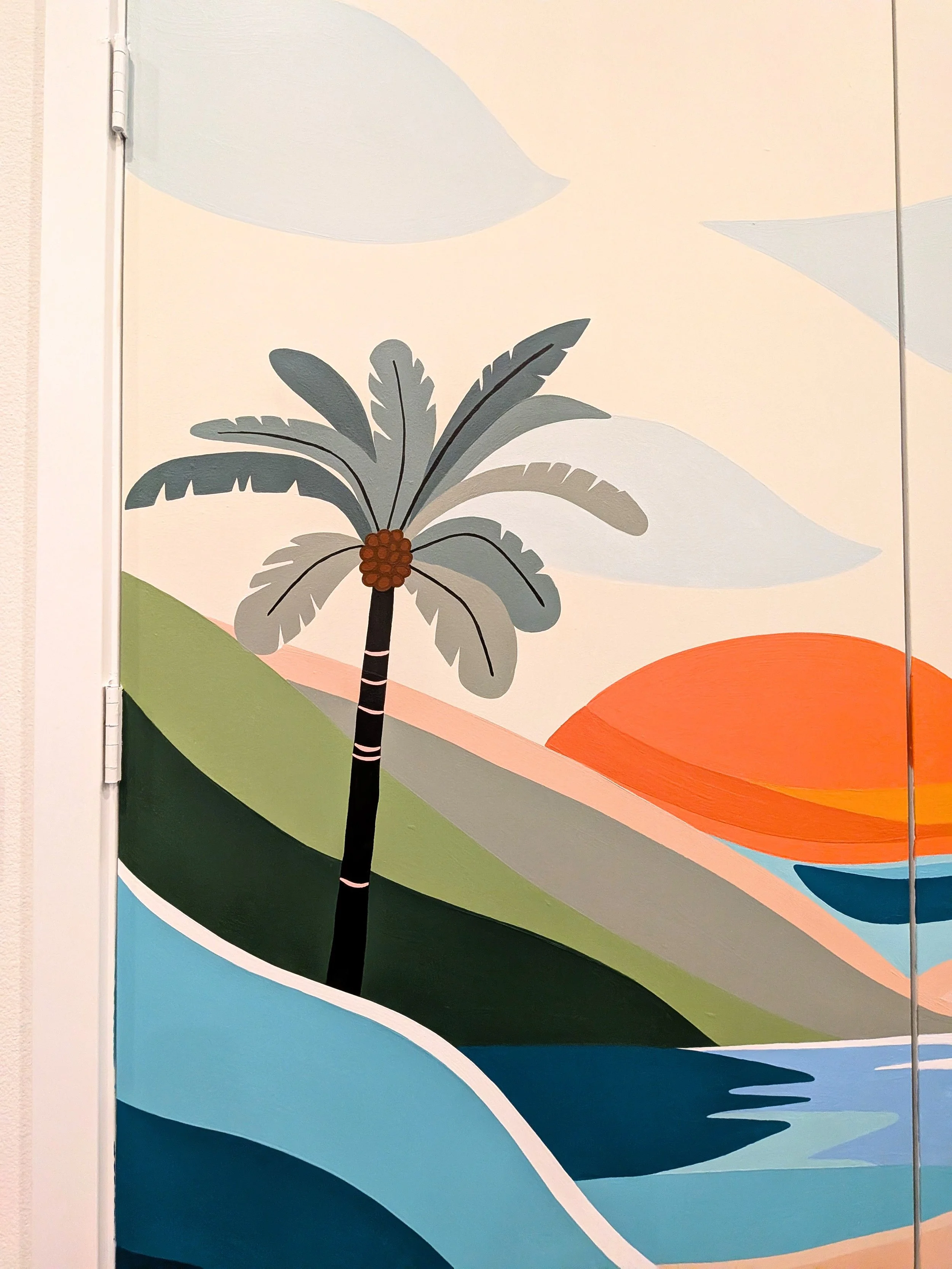 San Antonio apartment community fitness center mural featuring palm trees, water, a sunset, and a colorful tropical landscape.