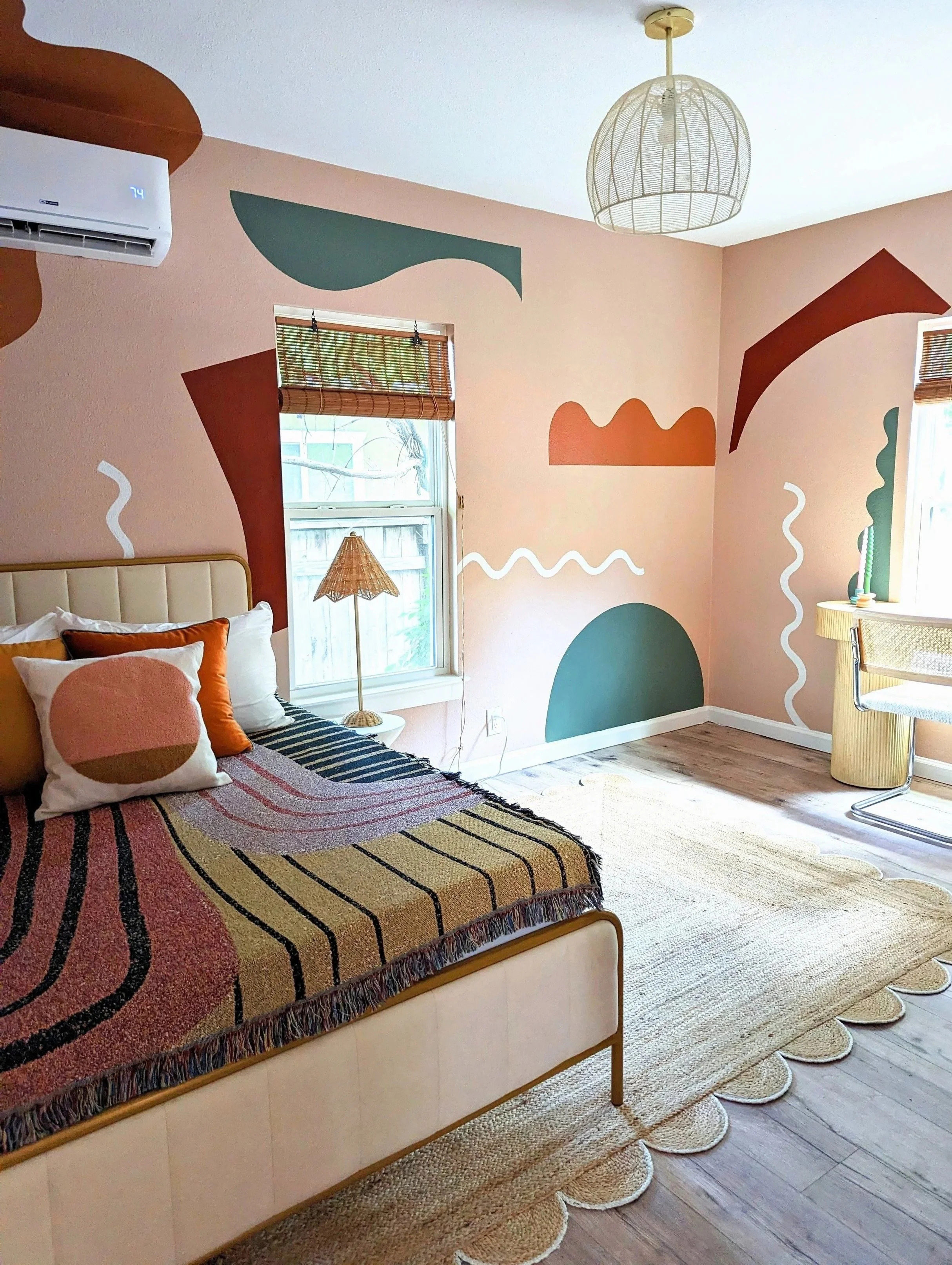 Retro bedroom mural in Austin featuring 70s-inspired colors, abstract shapes, and painted wall details. This was for a larger-scale Airbnb short-term rental where Tola Home also completed all of the interior design.