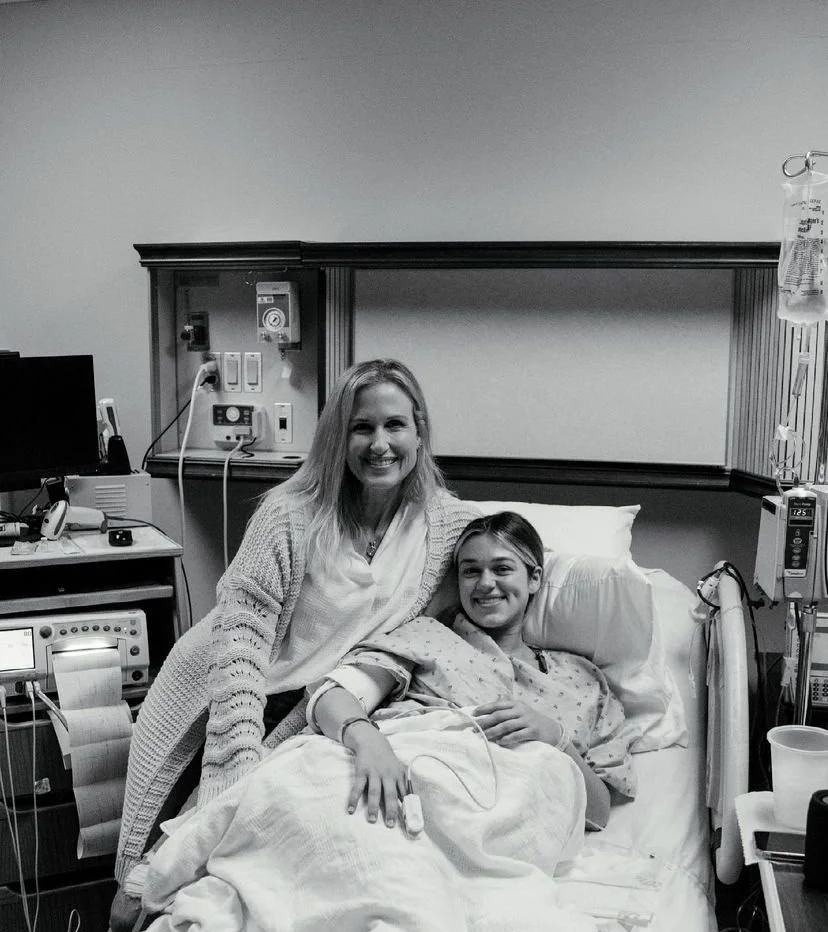 Mom & surrogate smiling in hospital bed