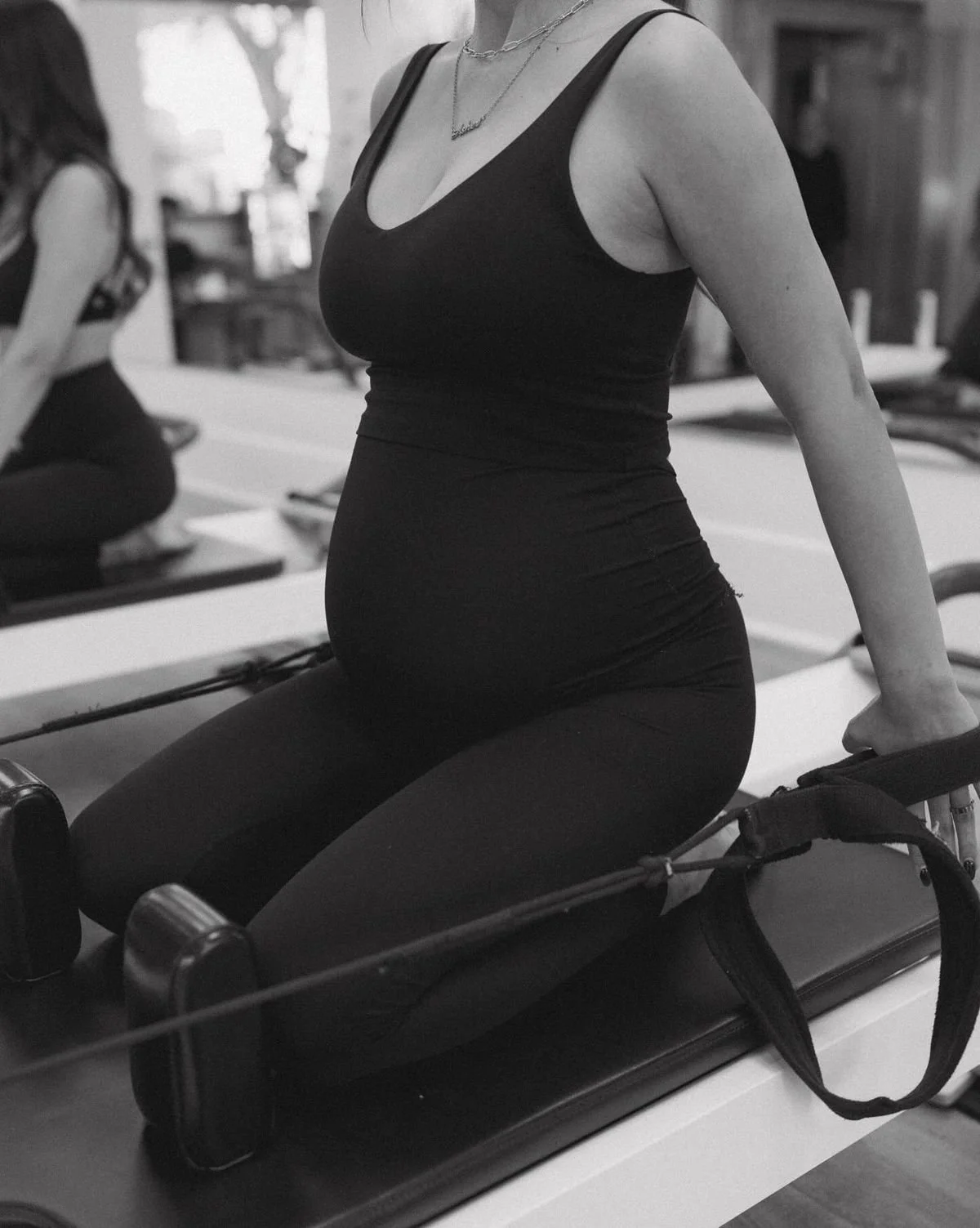 Pregnant woman on pilates reformer