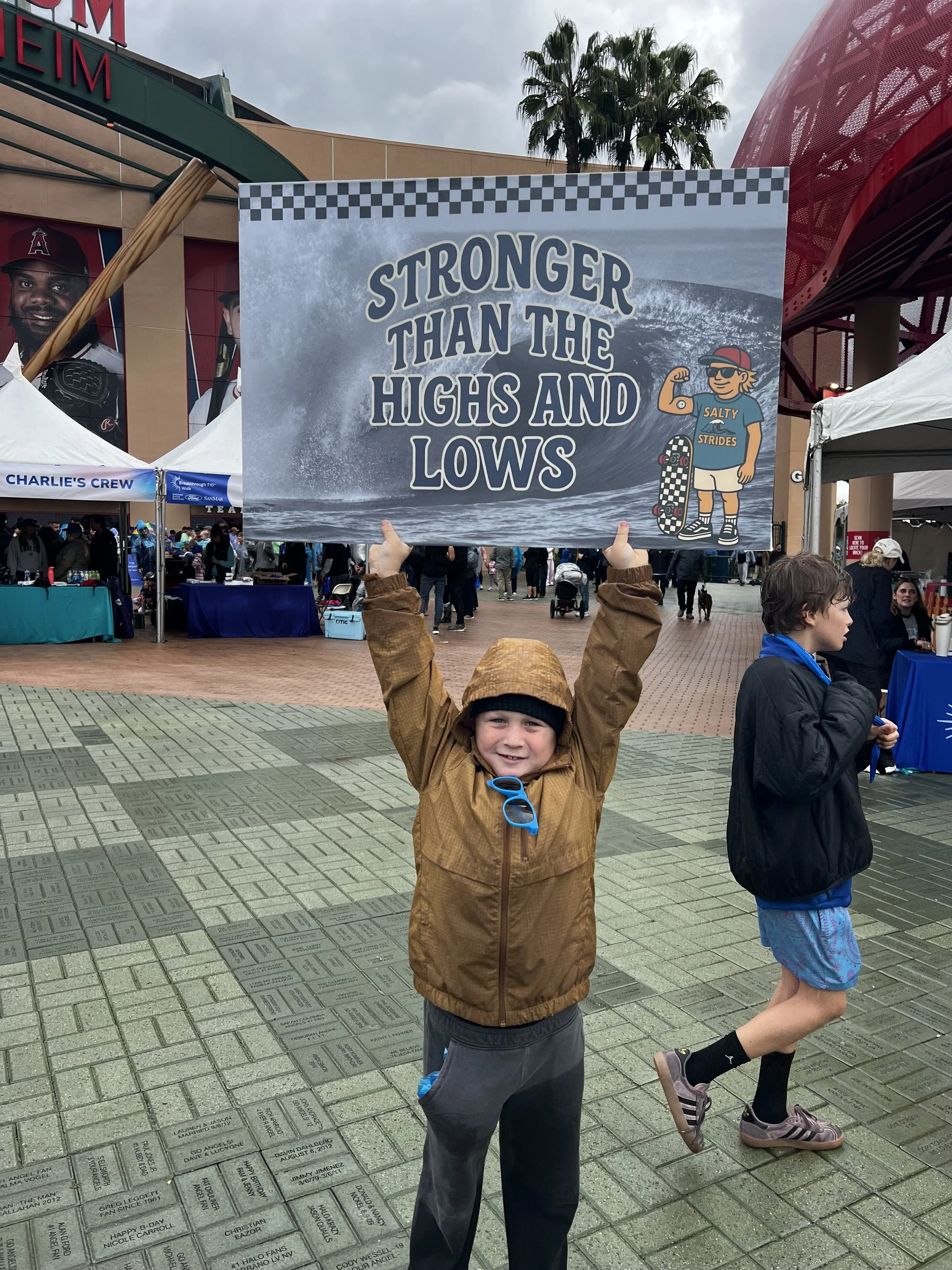 Brother supporting me holing up Salty Strides Sign 