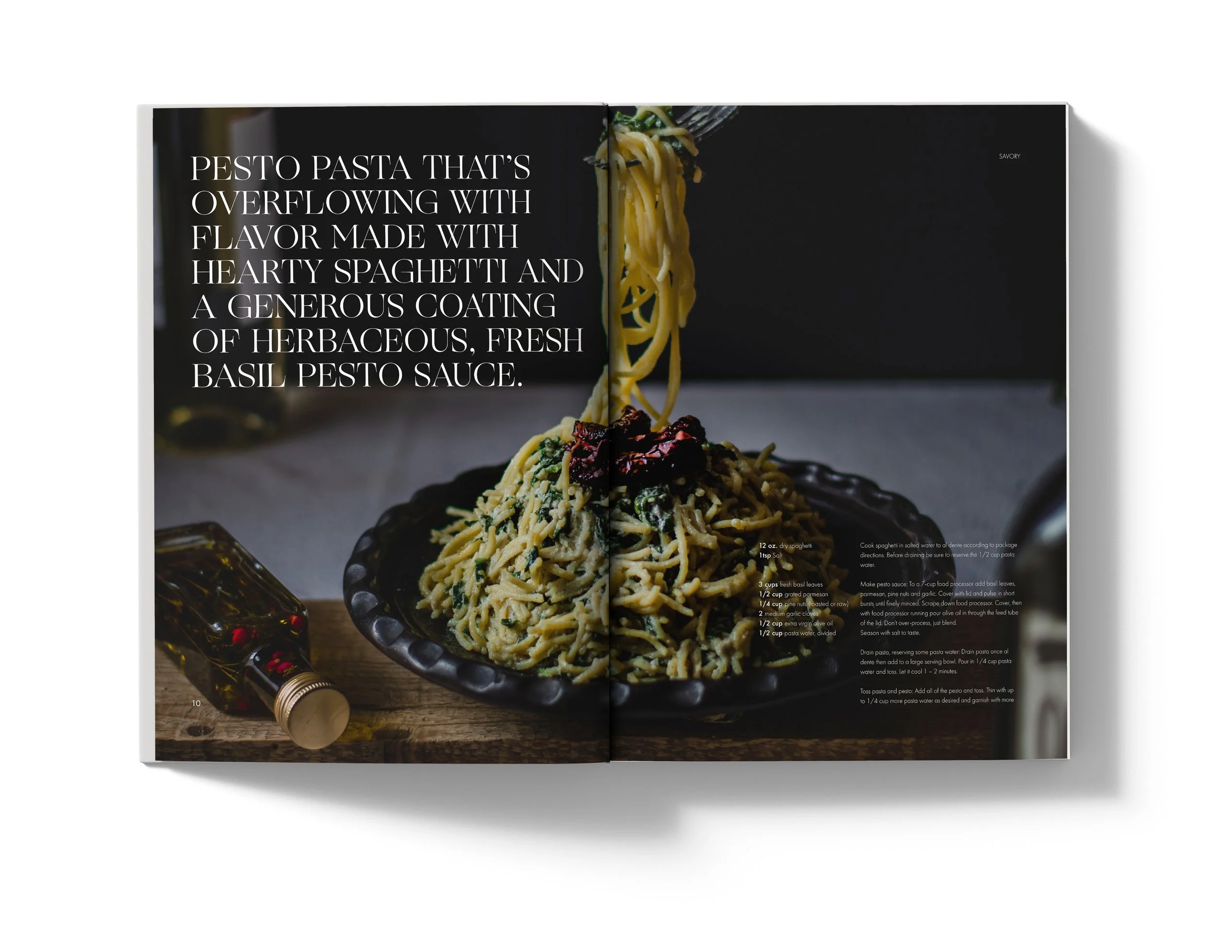 Open cookbook displaying a page with a photo of a plate of pesto pasta and recipe instructions.