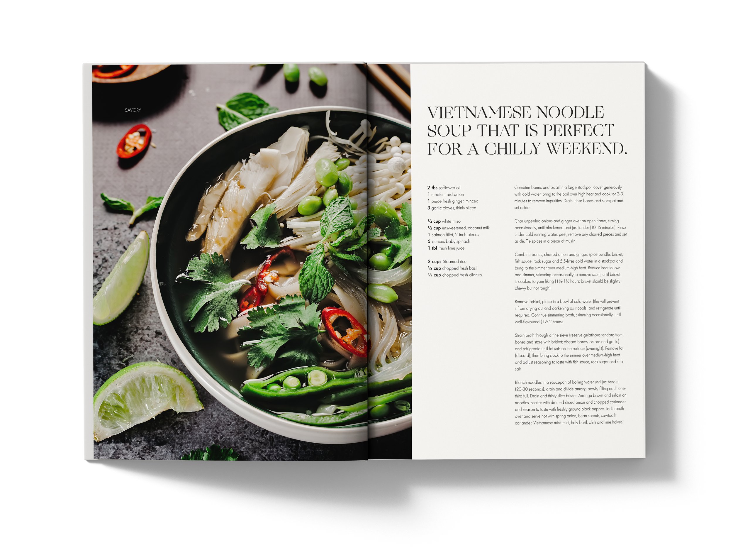 Open cookbook with a vibrant image of Vietnamese noodle soup with herbs, lime, and vegetables on the left page and a recipe on the right page.