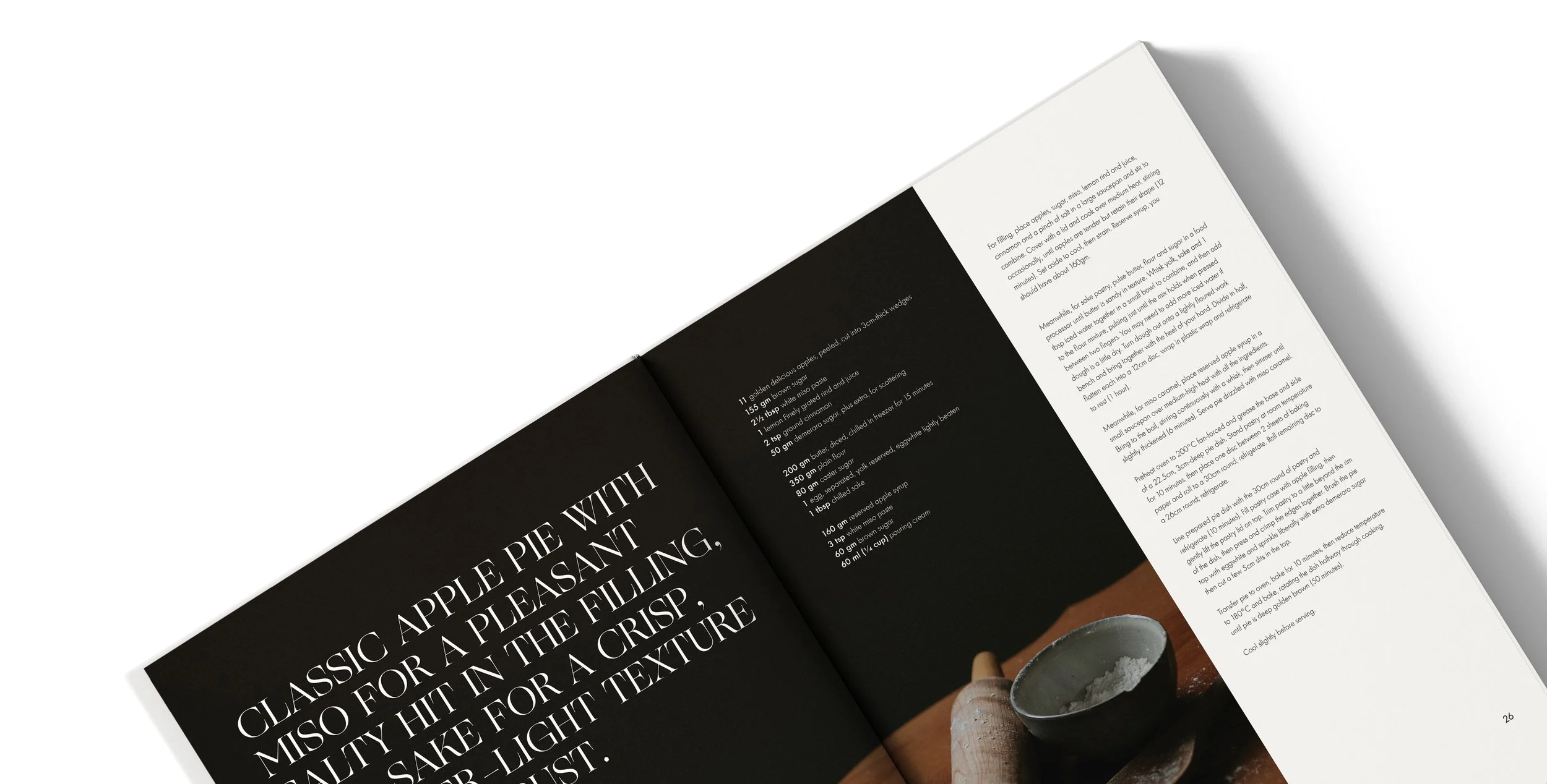 Open magazine featuring a recipe for apple pie. The left page has a black background with white text, and the right page shows close-up of ingredients and instructions with a partially visible apple pie image.
