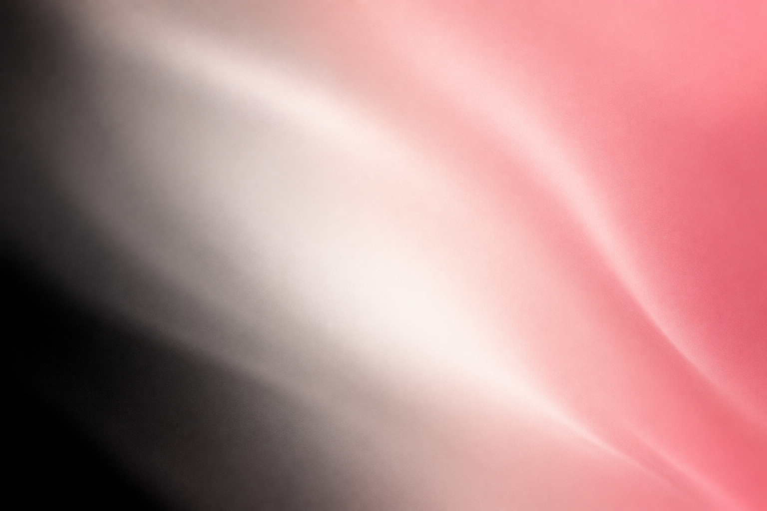 Blurred background with black, white, and pink colors.