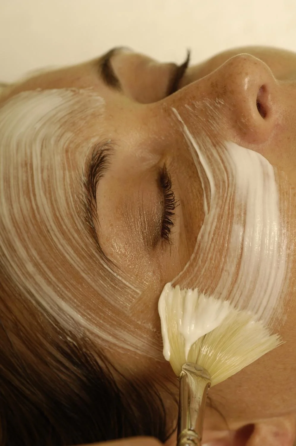 Relaxing custom facial treatment and skincare service being applied with a brush at Fable and Flora Esthetics.
