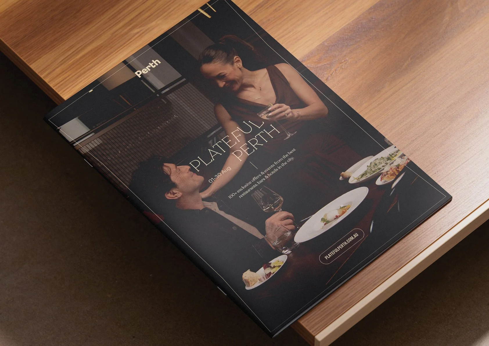 Brochure for Perth with a photo of a man and woman dining, with dishes on the table, promoting an event from August 1 to 30 with exclusive offers at restaurants, bars, and hotels in the city.