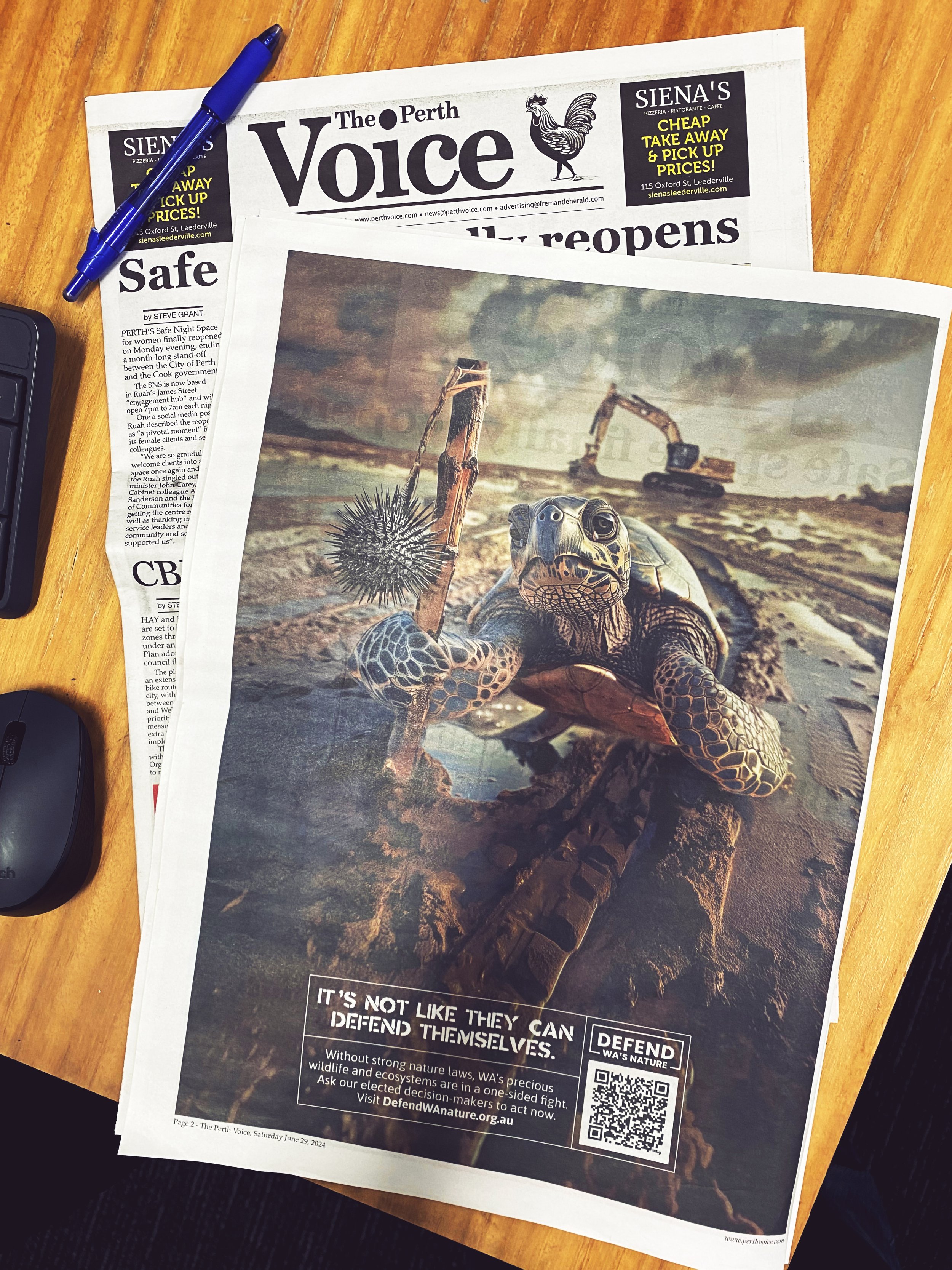 A newspaper titled "The Perth Voice" with an image of a sea turtle on a beach, construction equipment in the background, and text promoting wildlife conservation.