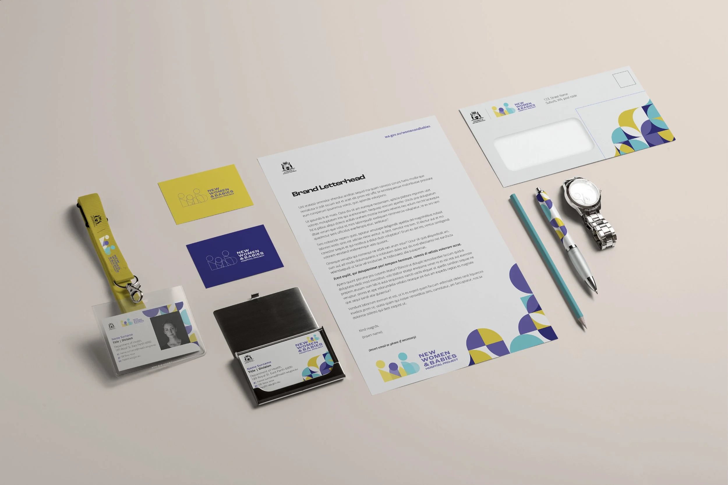 Array of branding materials for the 'New Women & Babies' hospital project, including business cards, ID badge, letterhead, lanyard, and envelope with colorful geometric logo pattern.