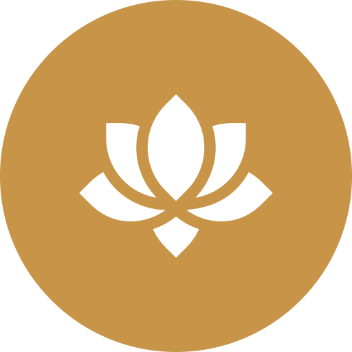 A white lotus flower symbol on a gold circular background.