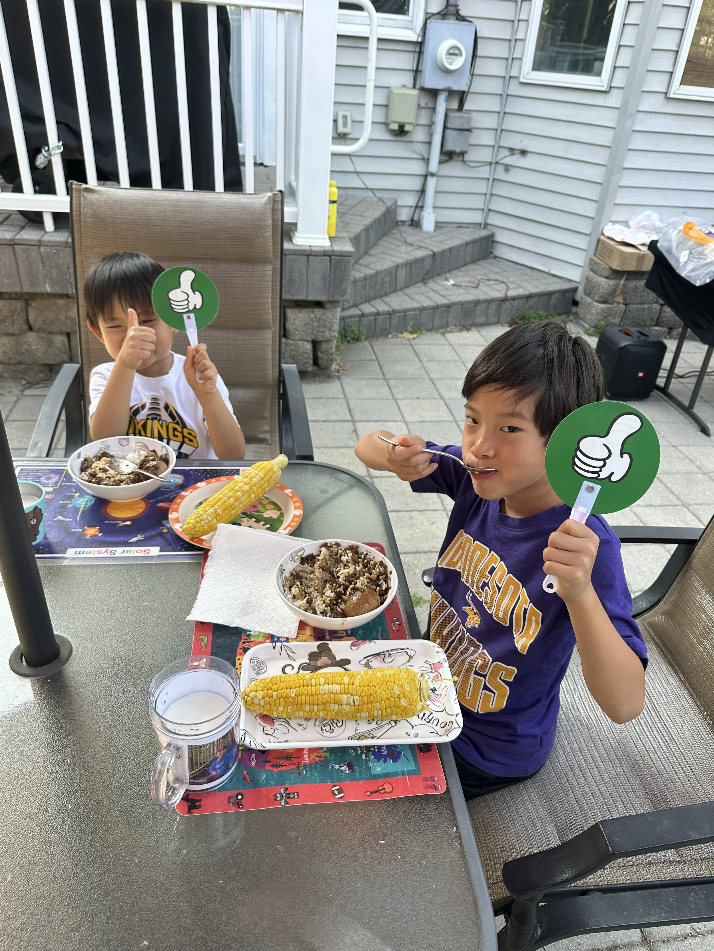 The "Two Sons" of Two Sons Taiwanese Food enjoying Taiwanese braised pork bian dang for dinner.