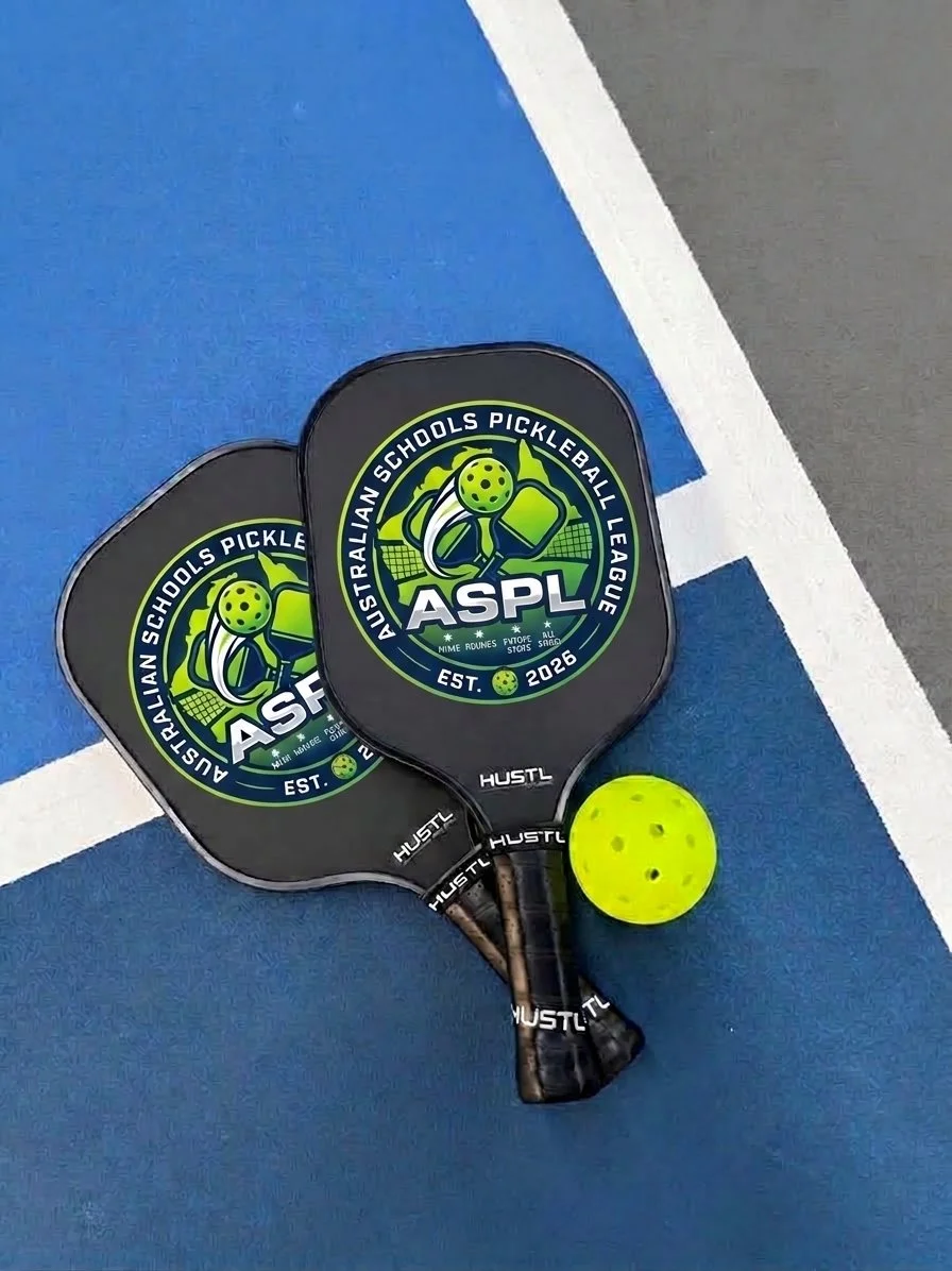 Two pickleball paddles with a logo that reads 'Australian Schools Pickleball League' and a yellow pickleball on a blue and gray court.