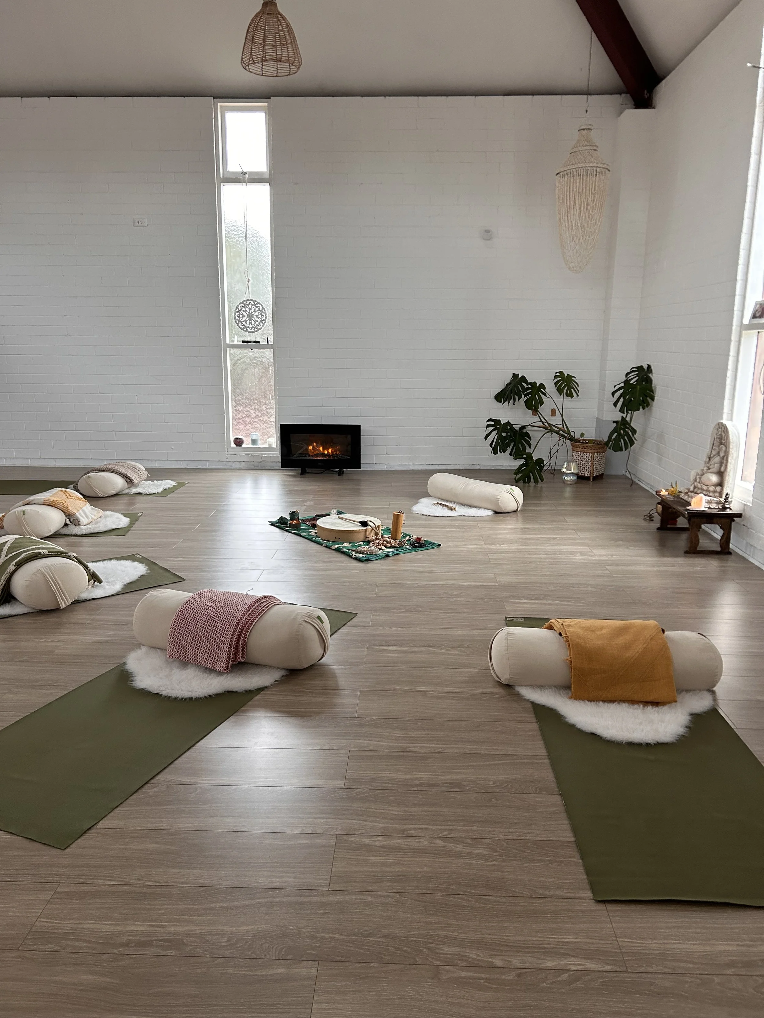 The Blue Mountains group breathwork circle space, with cushions, mats, and soft lighting set up for a session.